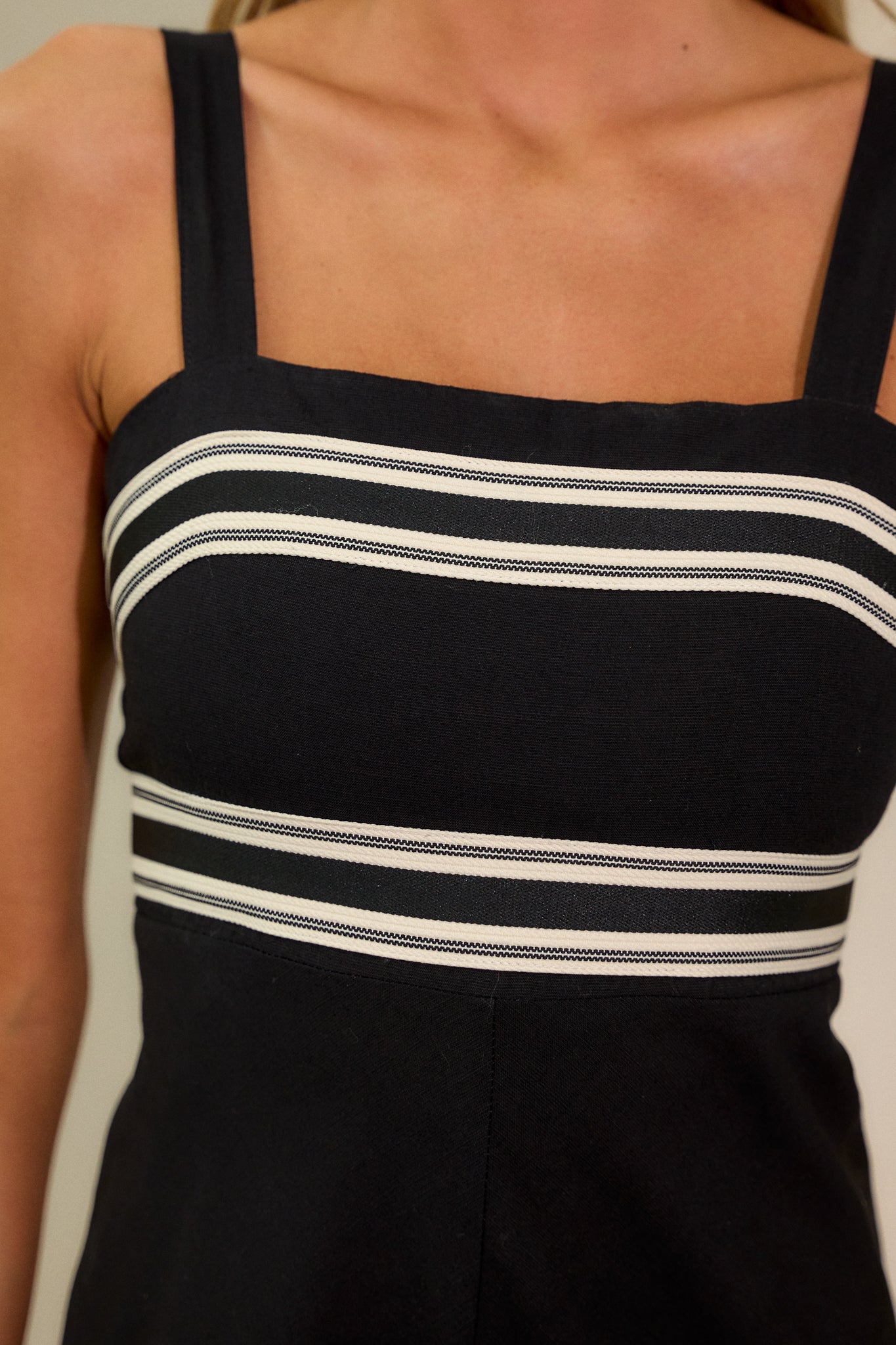 Close-up of the contrast detailing around the bust, waist, and bottom hem, focusing on the fine stitching and structure of the design.