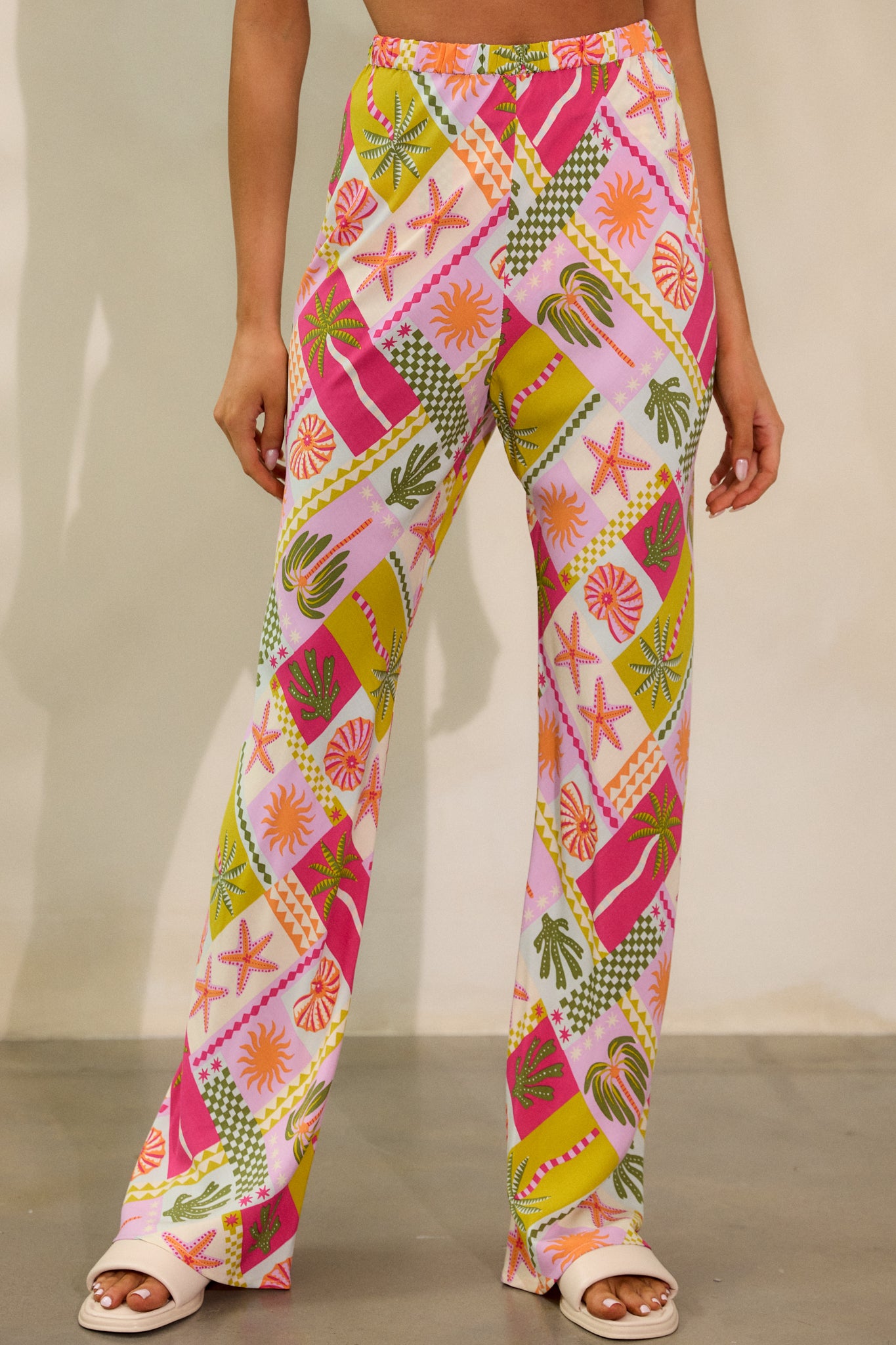 Focused shot of the pants’ legs, highlighting the straight leg bias cut design and the vibrant tropical pattern.