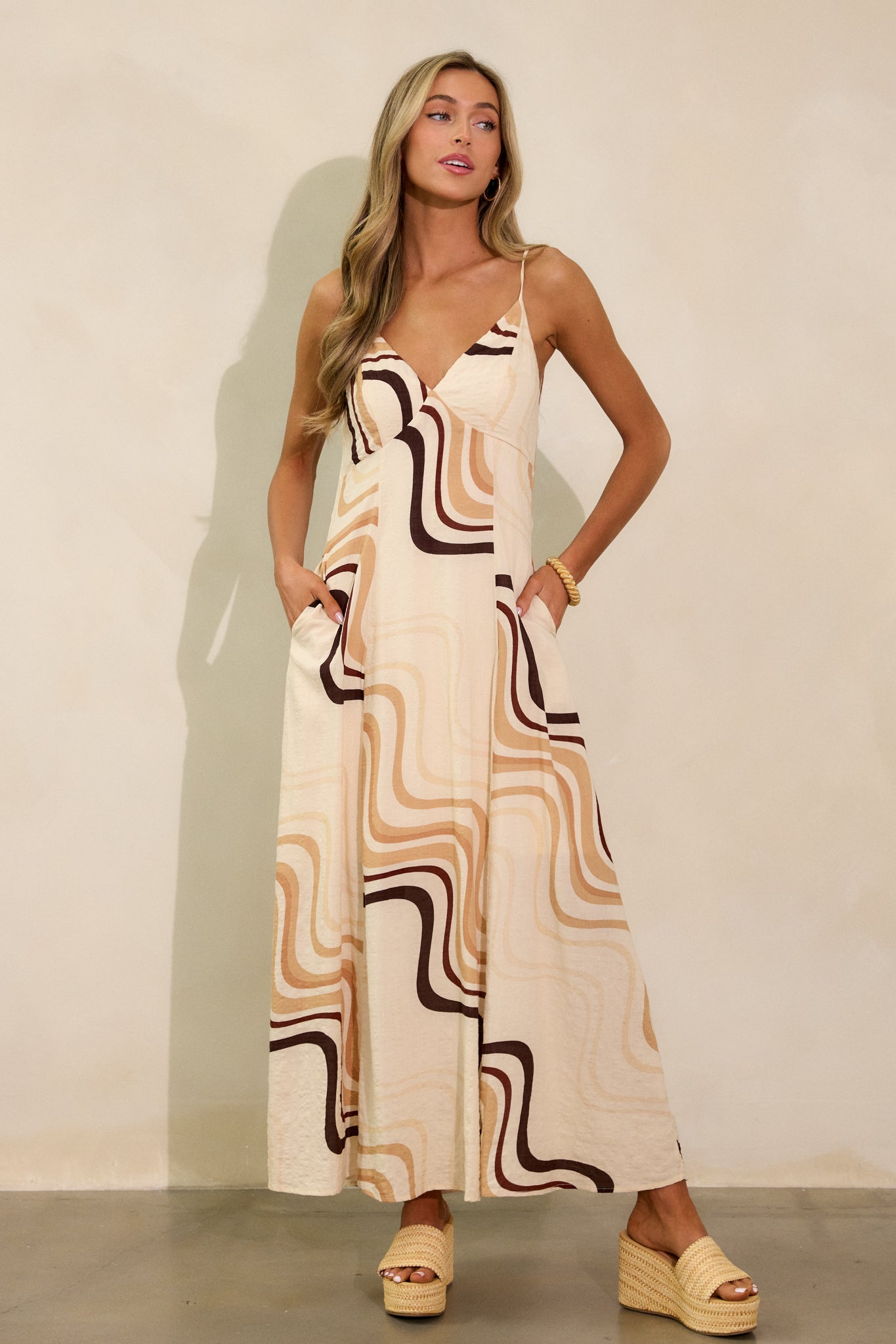 Another full-length shot of the beige maxi dress, focusing on the dress’s relaxed fit, tie back, and playful print.