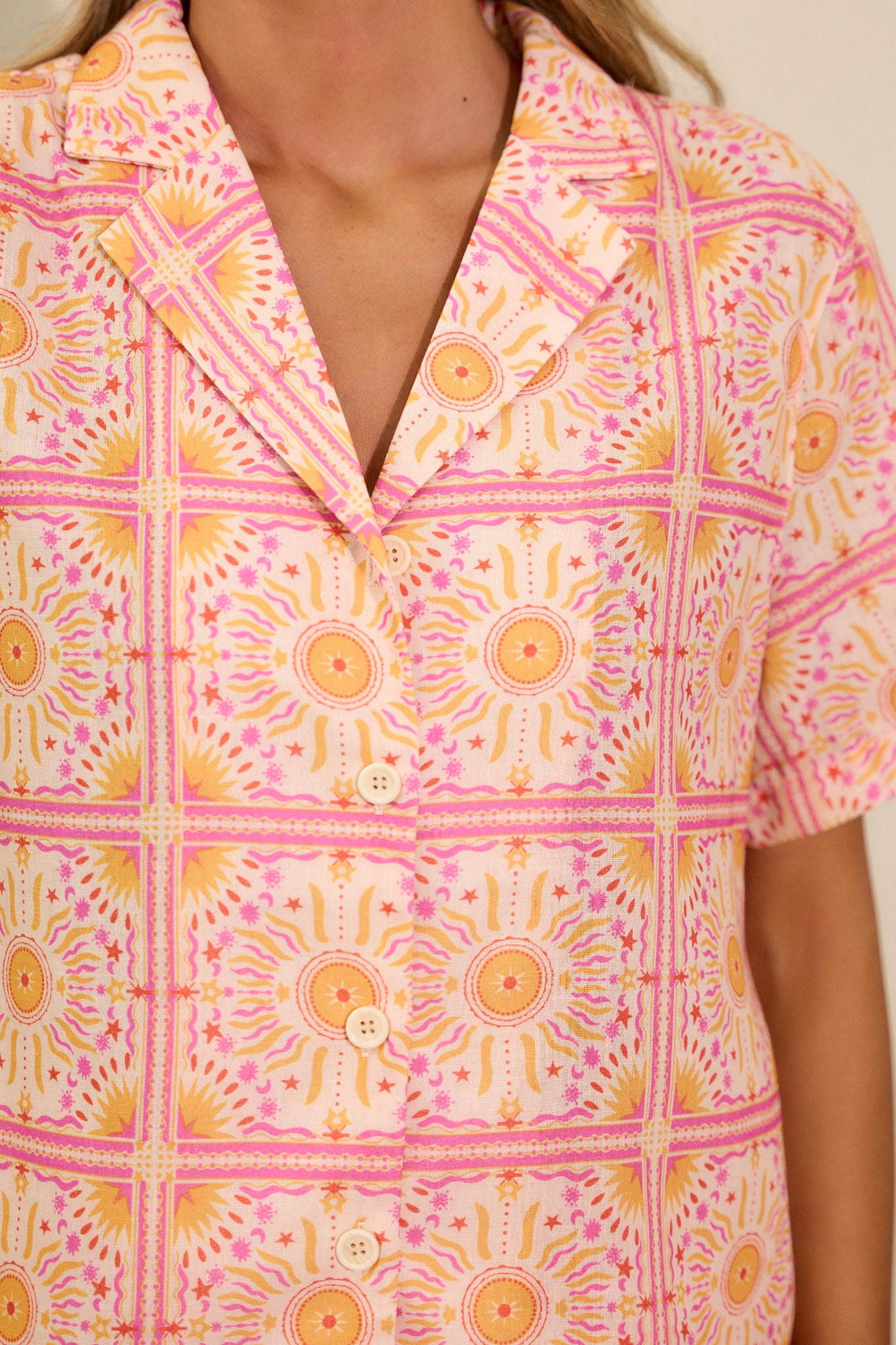 Detailed shot of the collar and buttons, emphasizing the fabric texture and unique print.