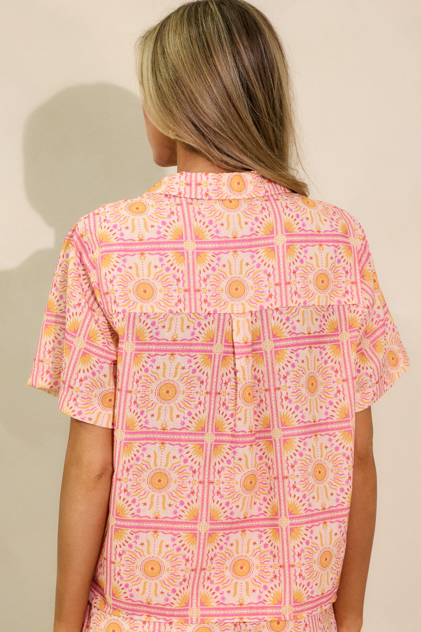 Back view of the pink top, showing the relaxed fit and the continuation of the print on the back.