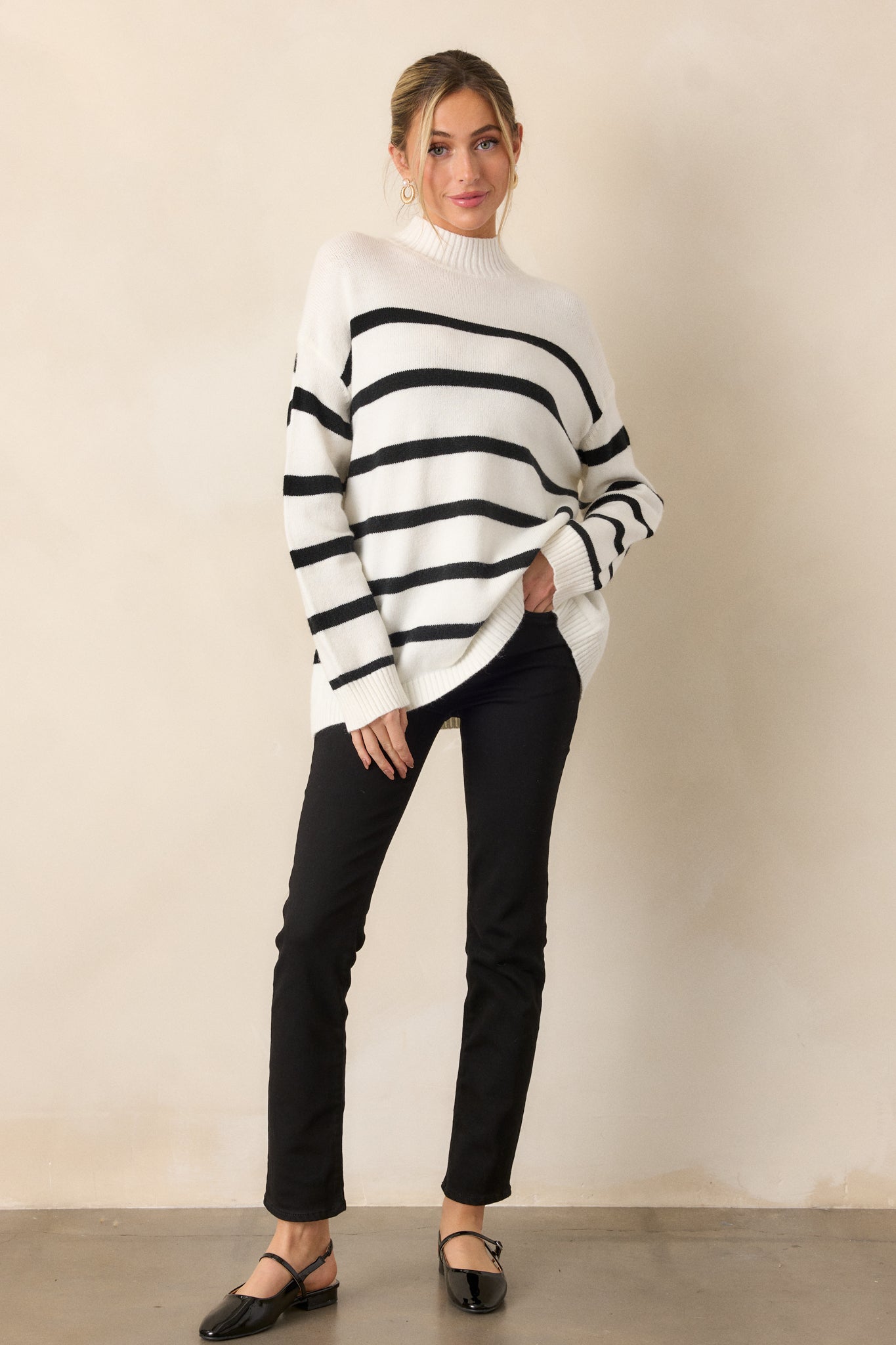 Full view focusing on the high mock neck and wide, comfortable fit, with the black stripes creating a classic pattern across the body.