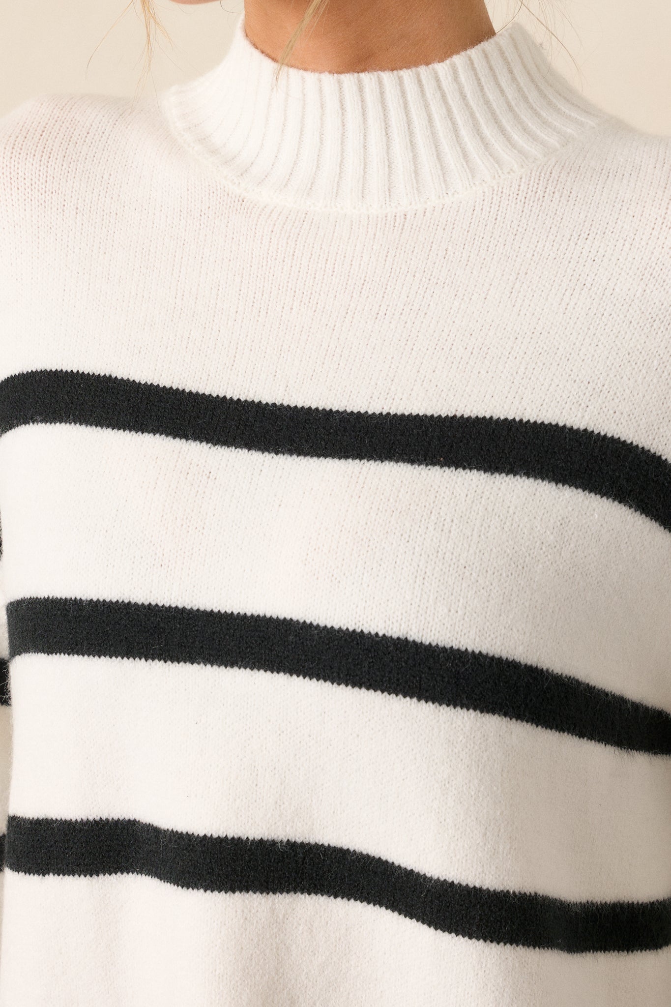 Detailed view of the ribbed texture around the mock neck, showing the fine knit and black stripe detailing.