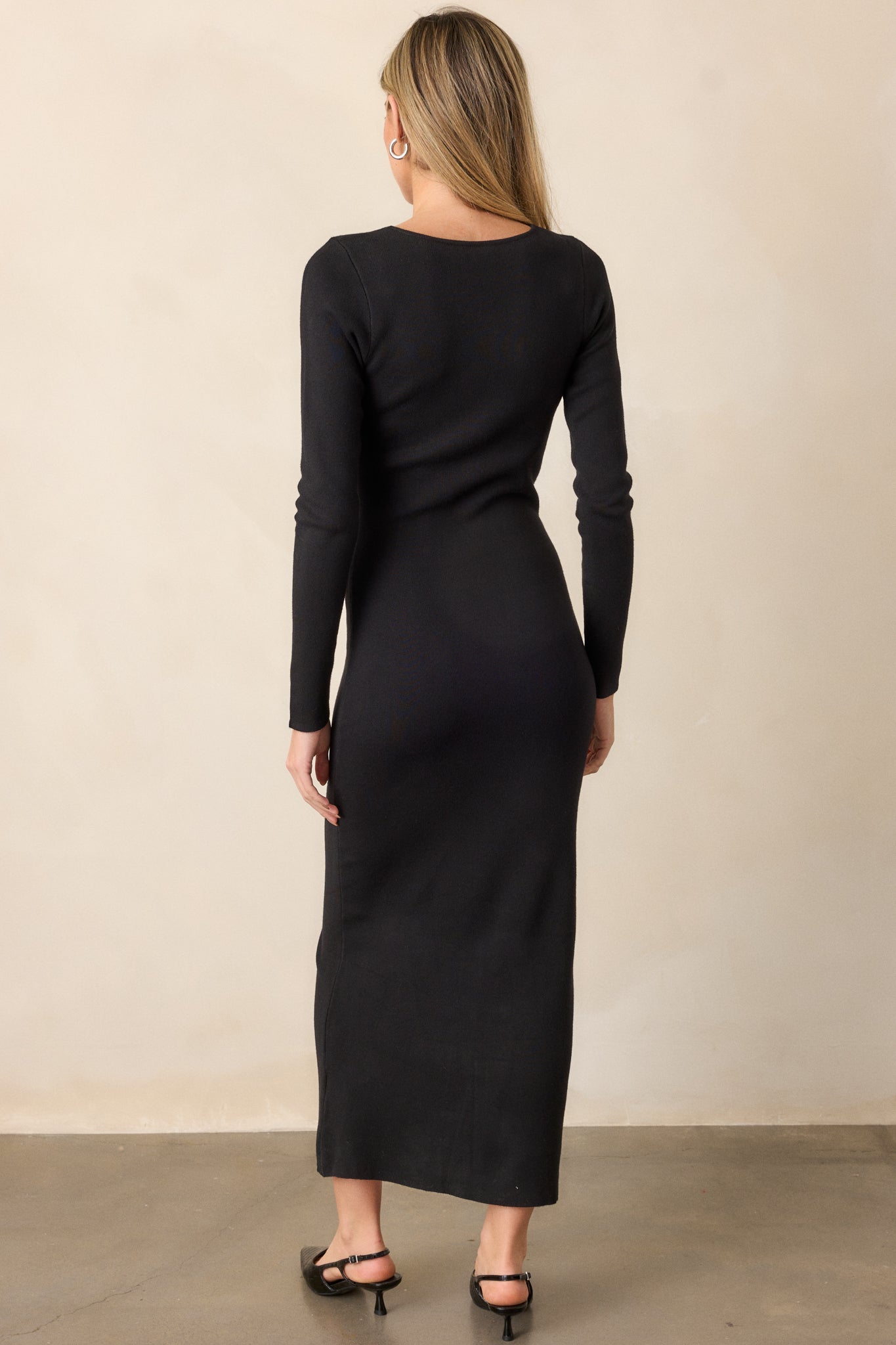 View of the back of the dress, featuring the seamless knit fabric, long sleeves, and the smooth, unbroken line from top to bottom.