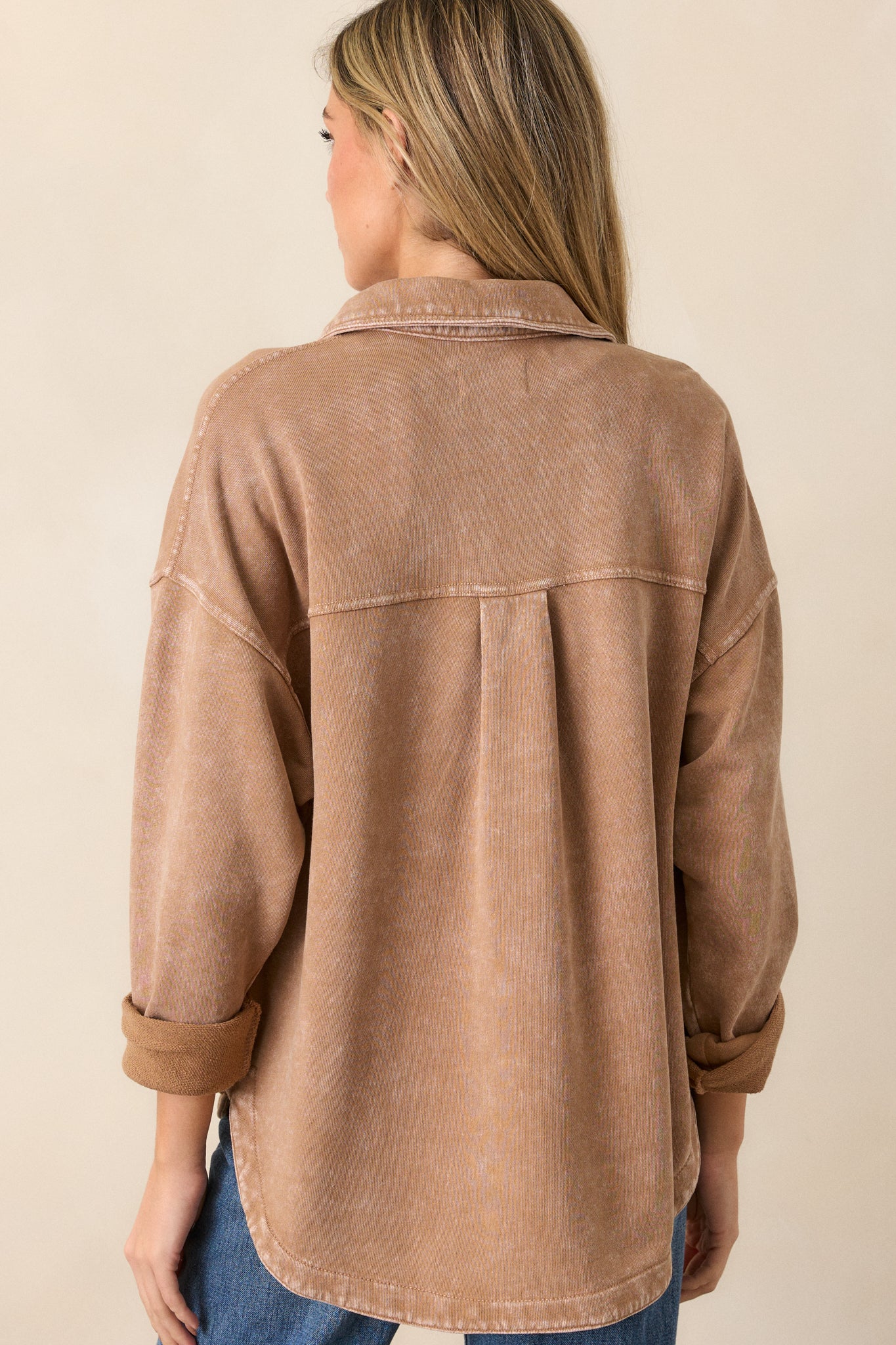 Back view of the jacket highlighting the dropped shoulders and the back of the collar, with a glimpse of the chest pockets from the side