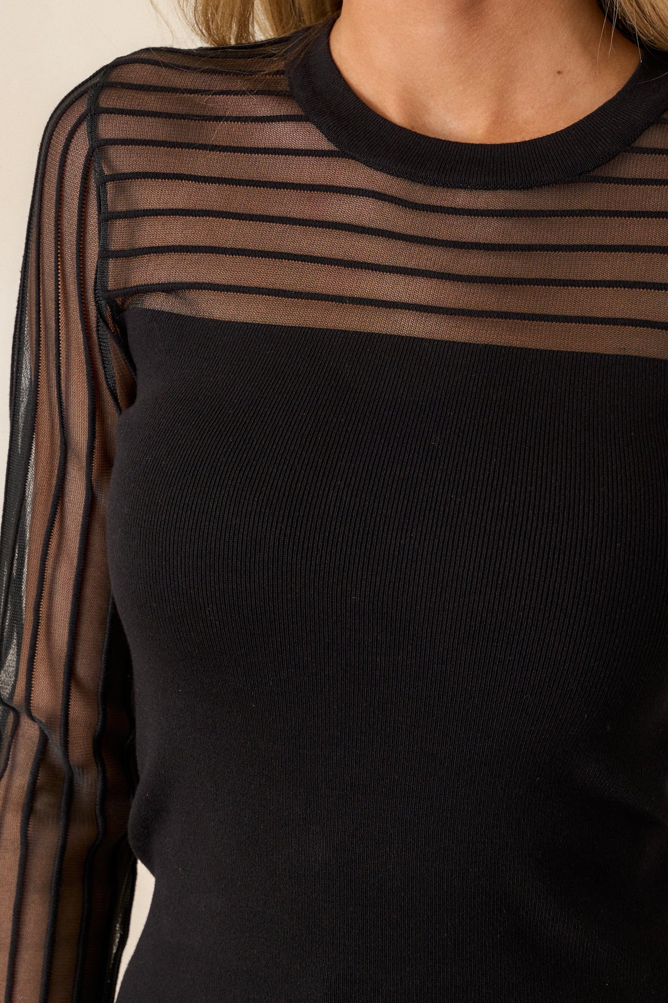 Detailed shot of the ribbed knit texture, emphasizing the fabric’s softness and stretch, with a focus on the fitted cut.