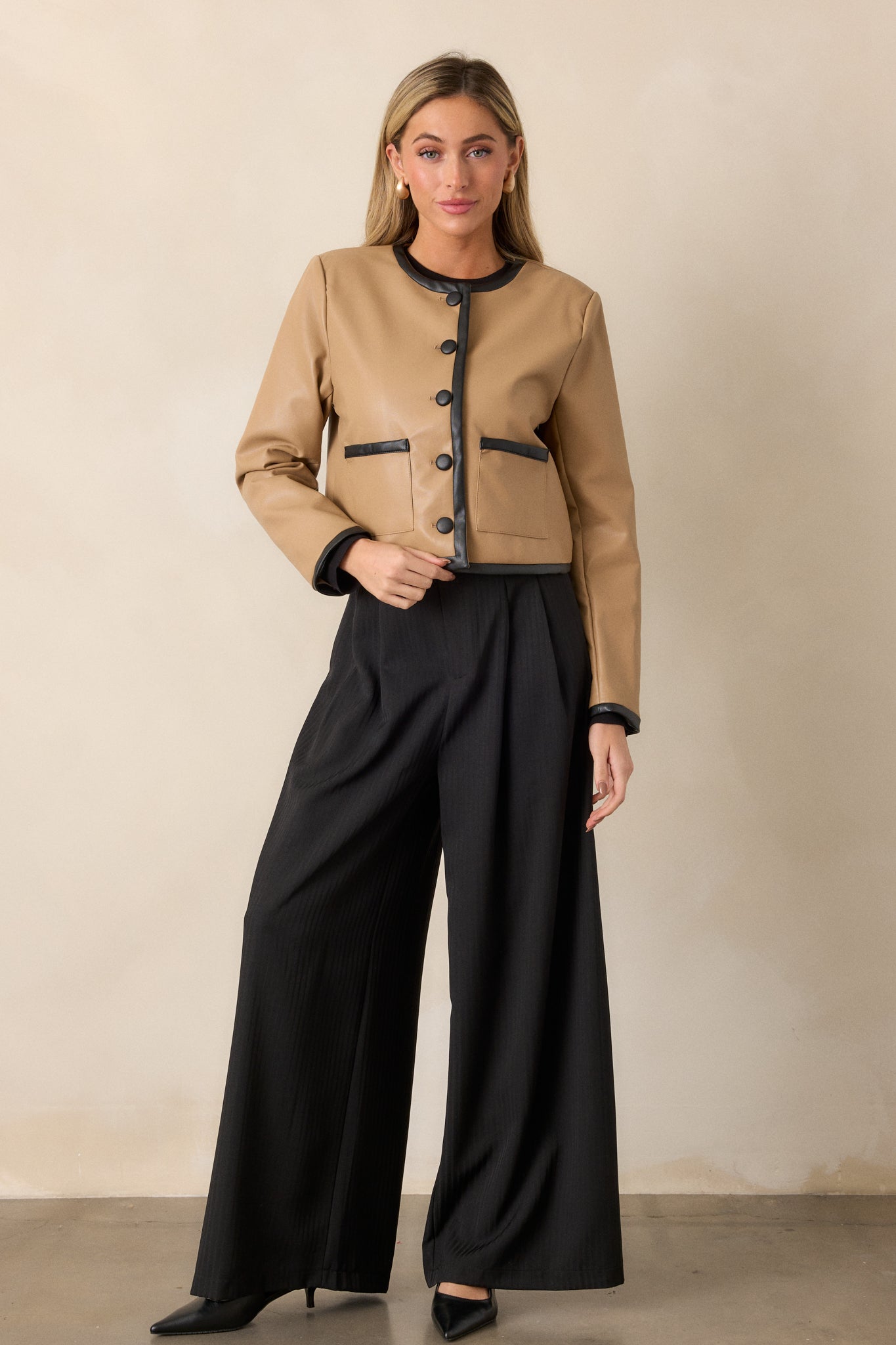 Front view of the trousers, showcasing the wide-leg fit, high waist, and slight gray stripe detailing.