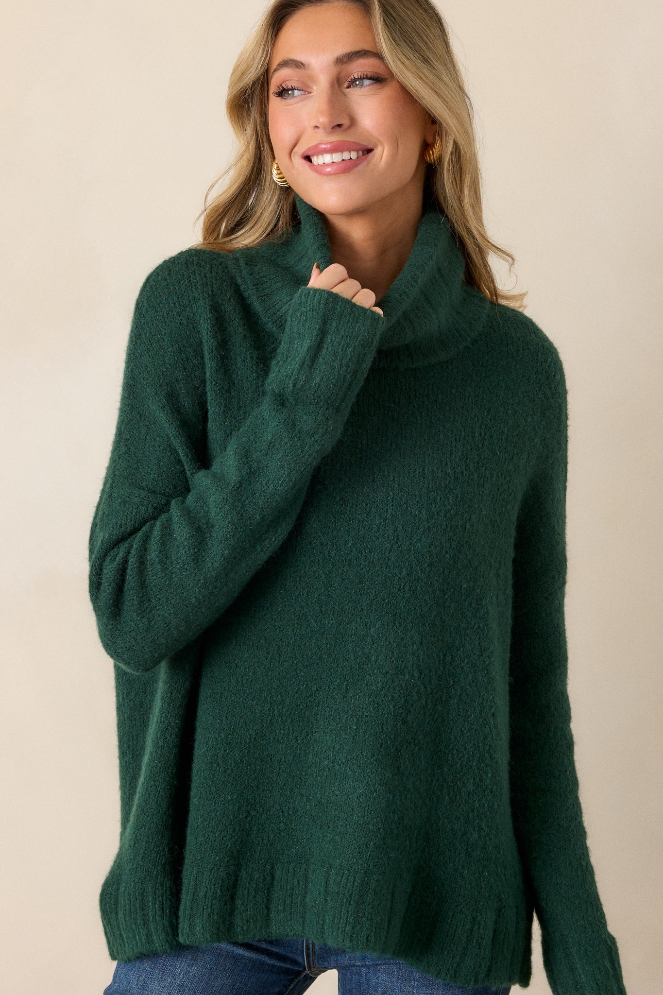 Cropped view of this hunter green sweater that features a very light eyelash knit design and a turtle cowl neckline.