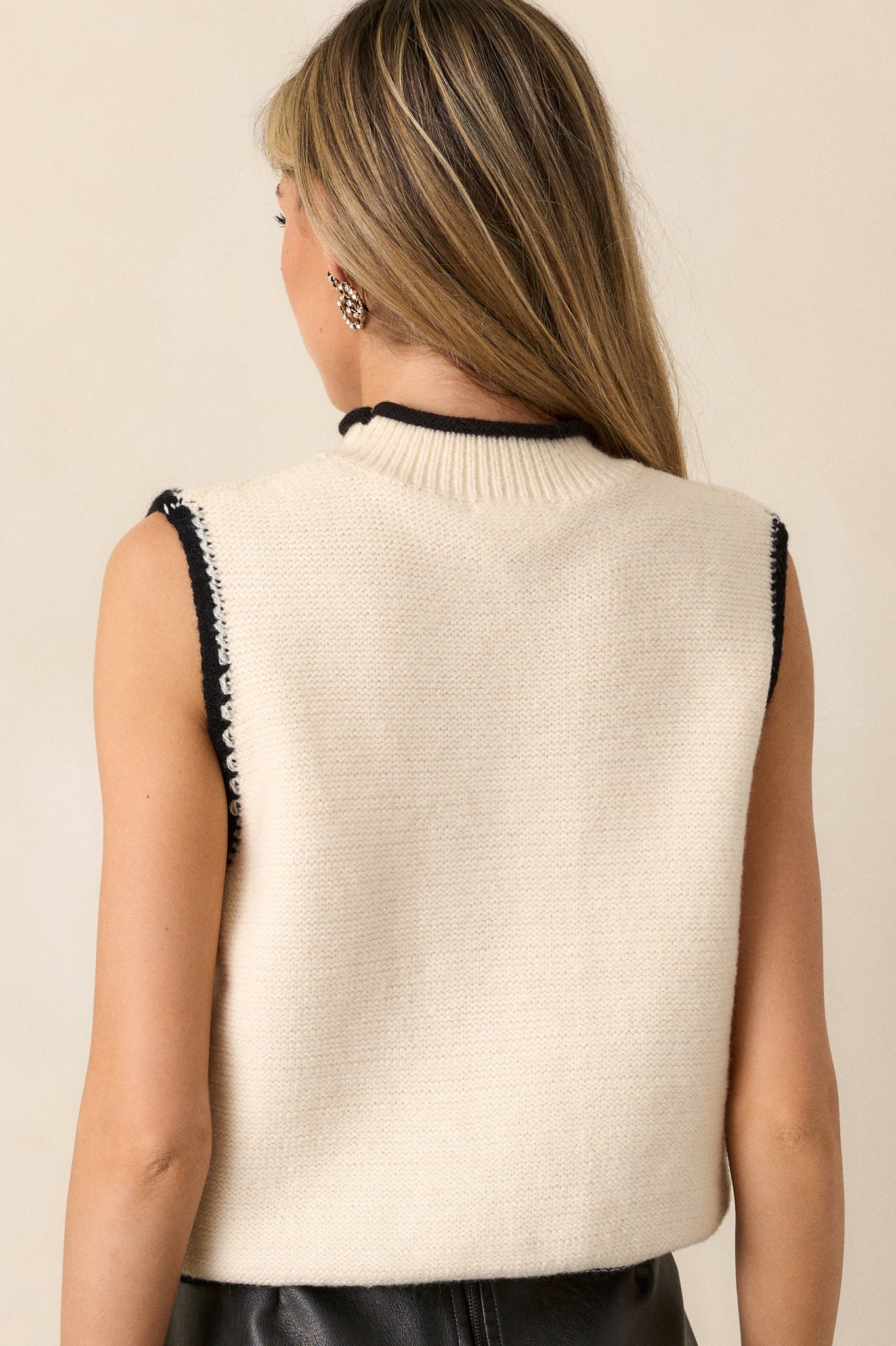 Back view of the top, showcasing the sleeveless design and relaxed fit, with the clean lines and soft fabric visible.