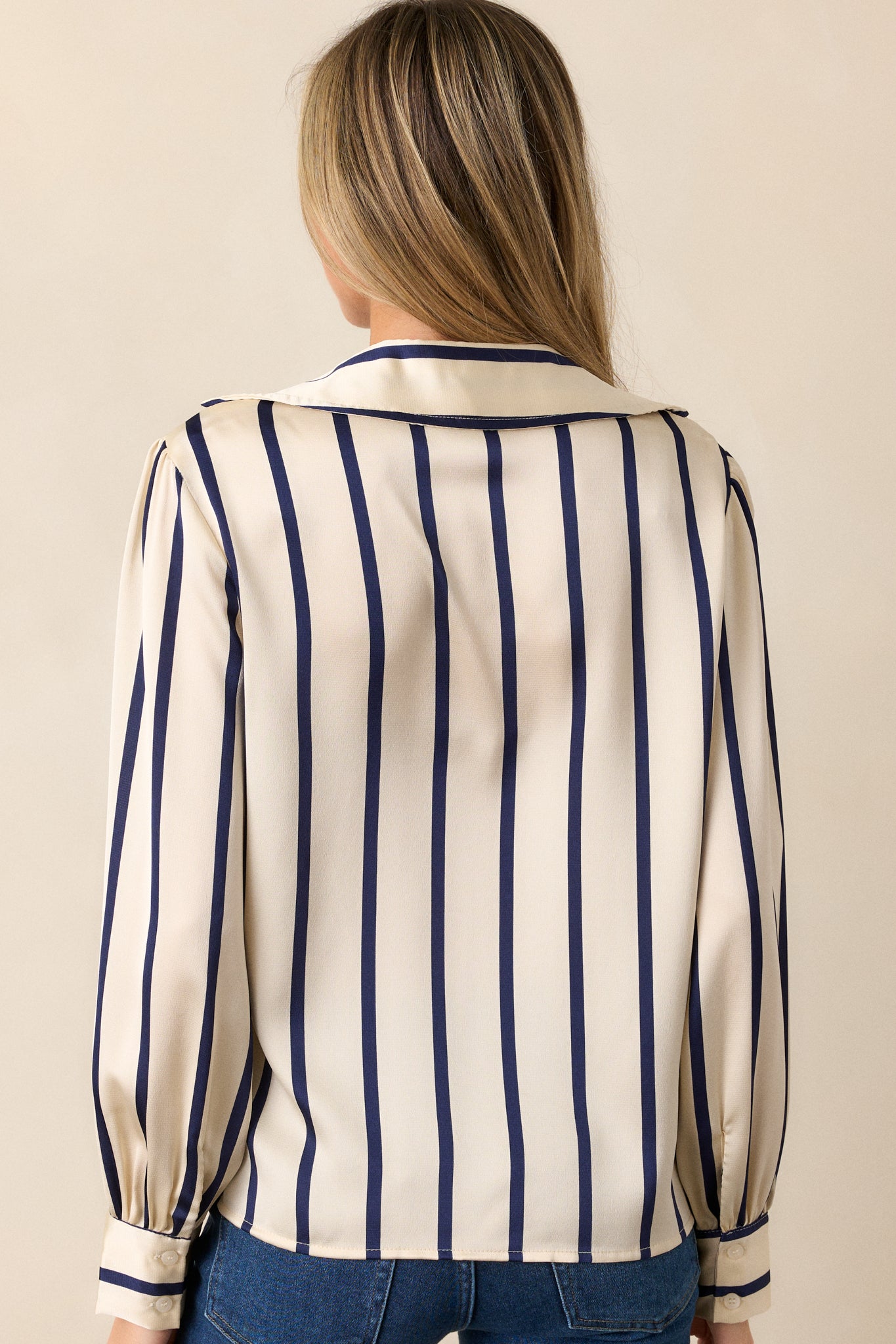 Back view of the blouse, showing the vertical navy stripes and the relaxed fit of the back panel.