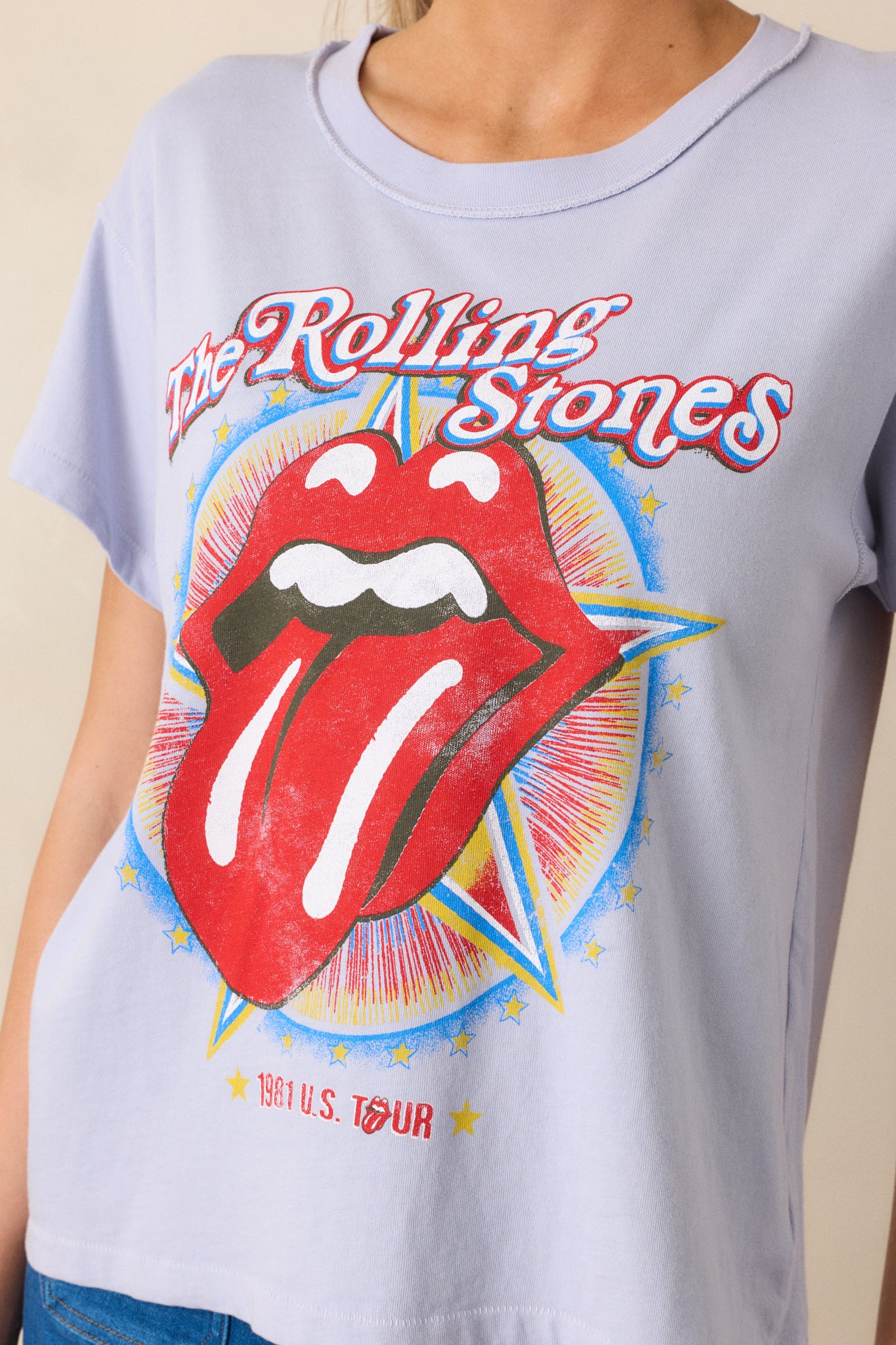 A cropped shot focusing on the round neckline and the "Rolling Stones 1981" graphic on the front. The lavender color adds a soft, modern contrast to the bold, classic logo.