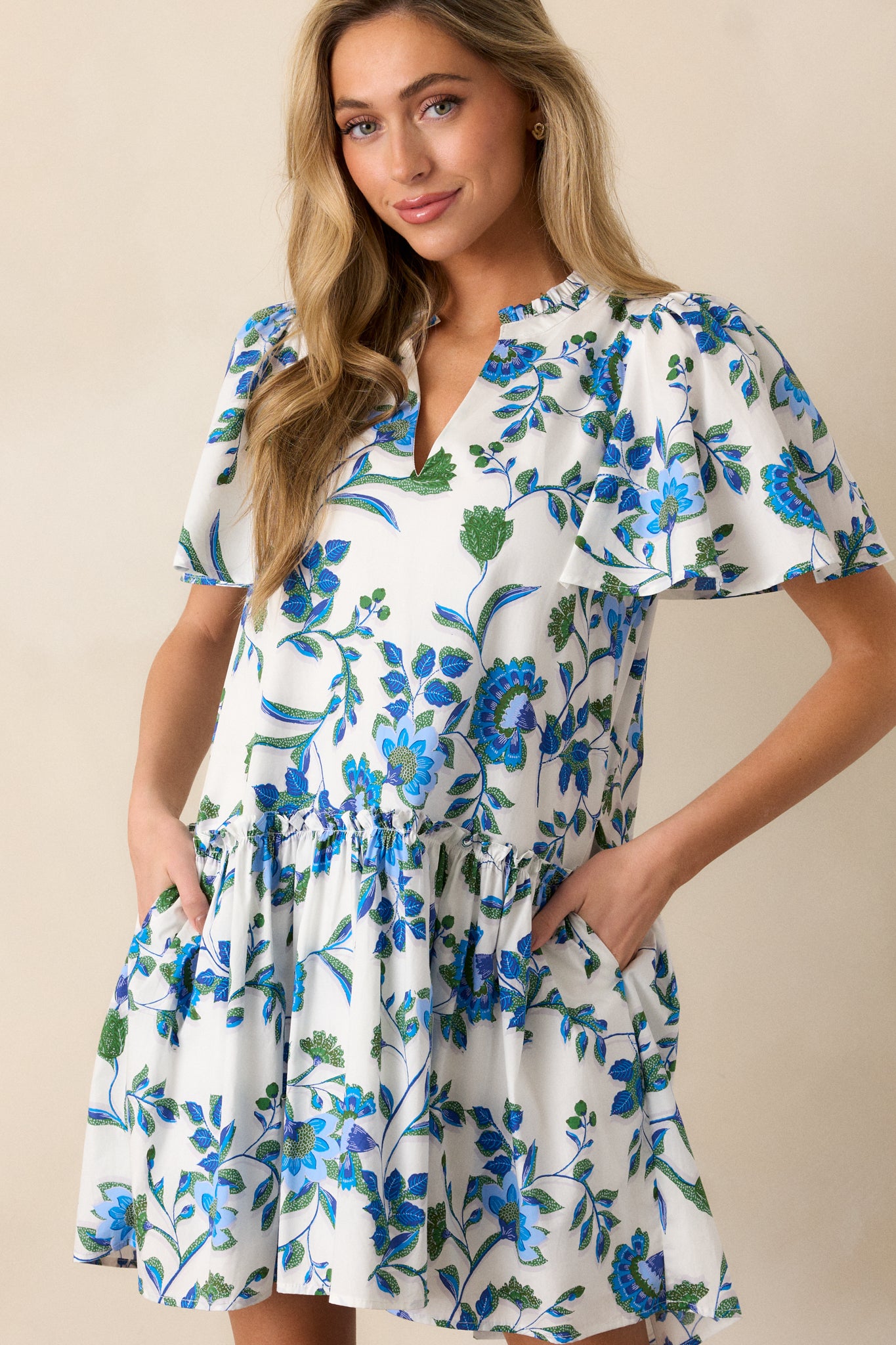 Focused view of the dress’s sleeve and shoulder, displaying the short sleeve design and floral details.