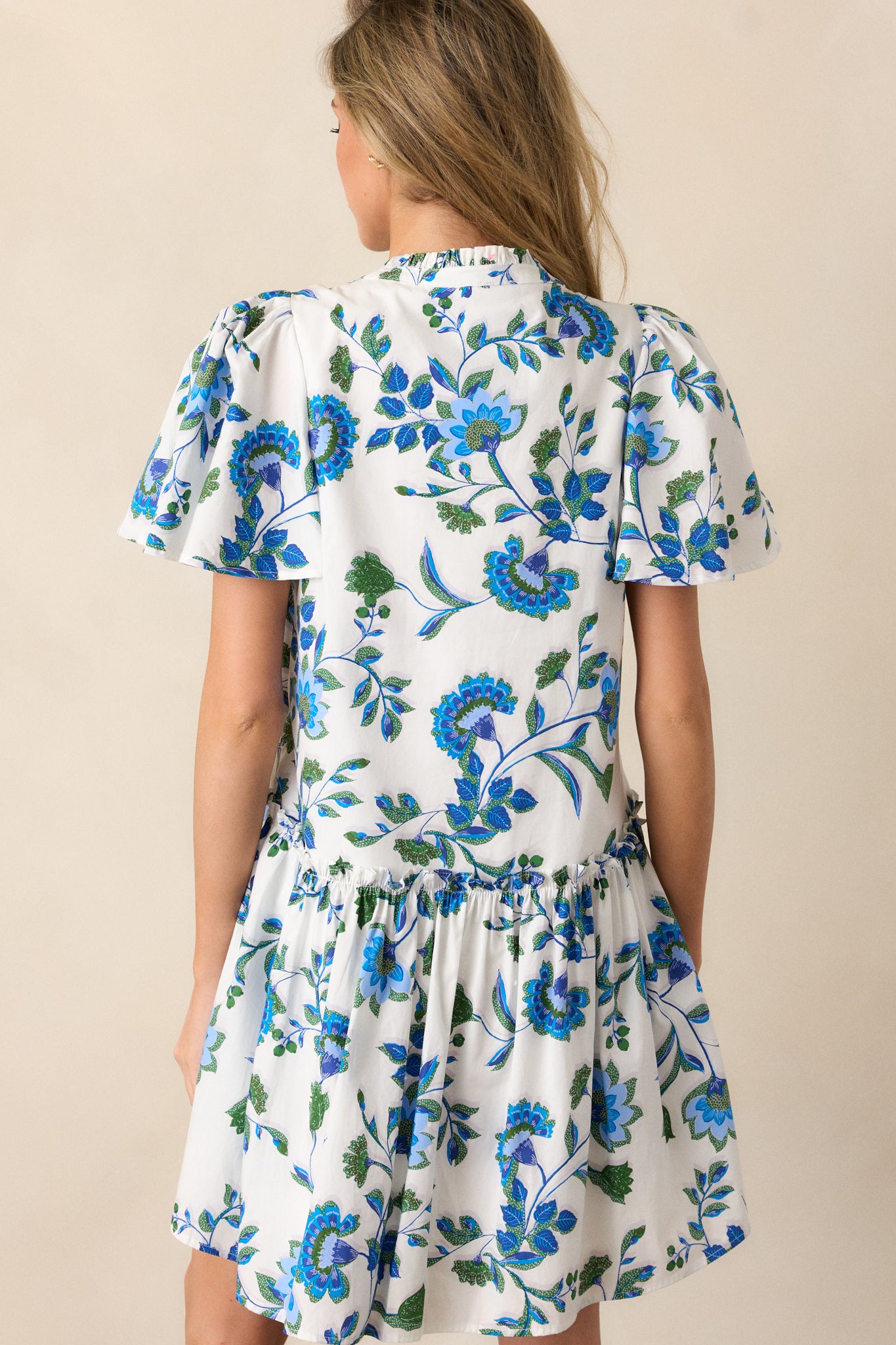 Back view of the dress, showcasing the relaxed fit, short sleeves, and single tiered structure from behind.