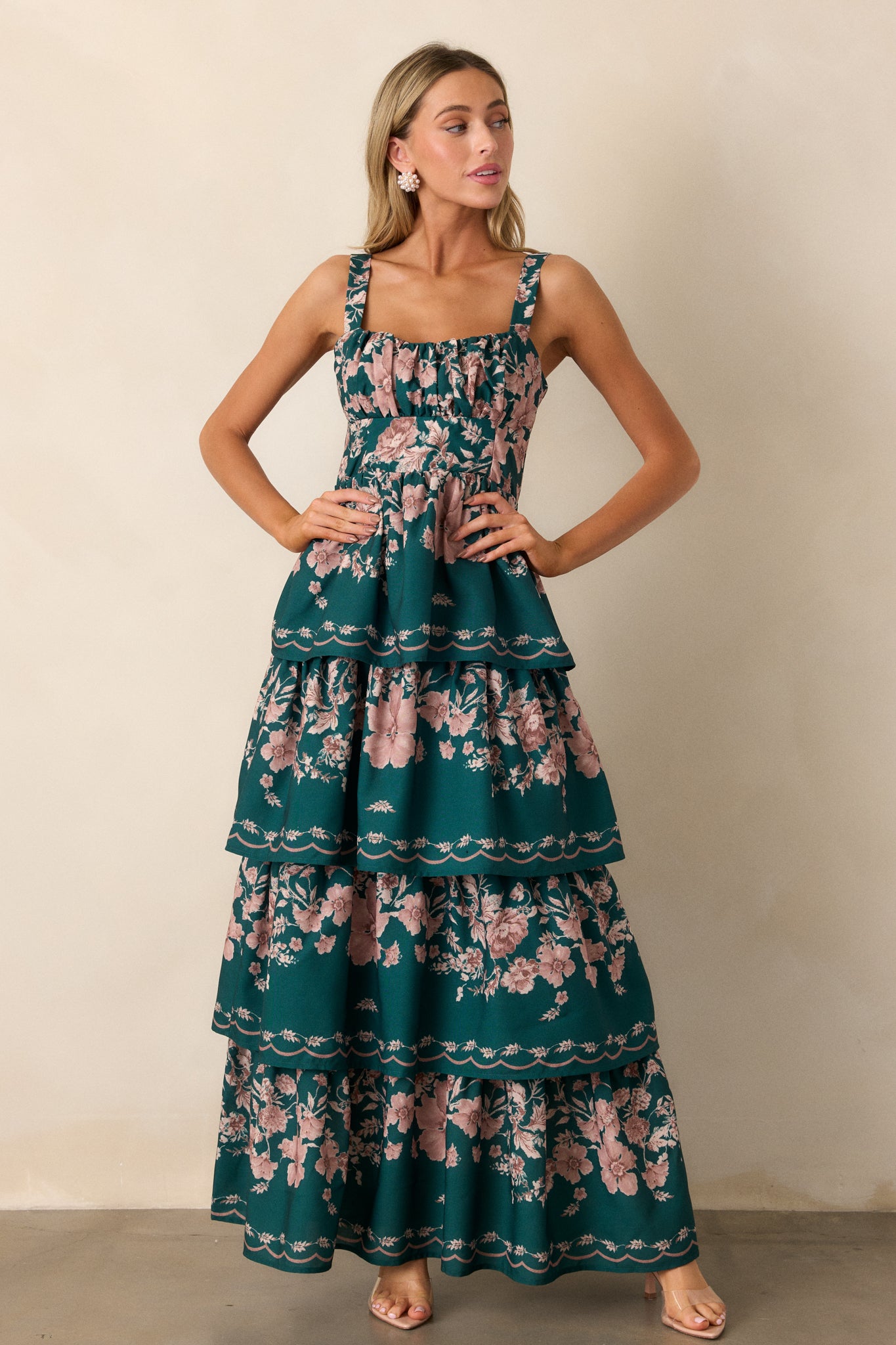 This green dress features four flowy tiers, adjustable straps and a back functional zipper