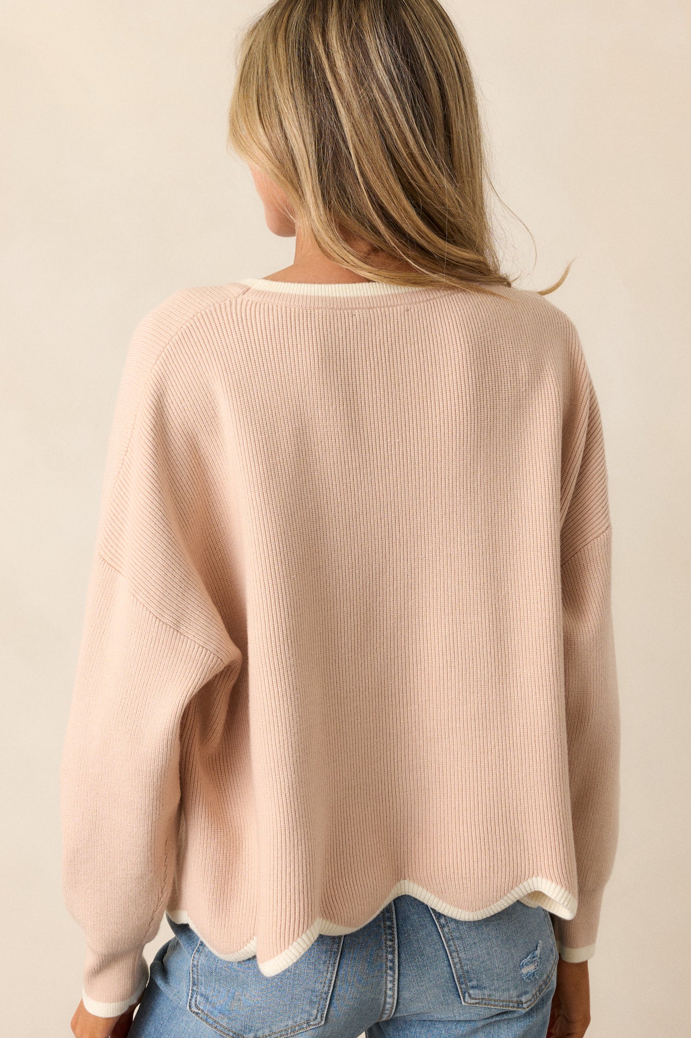 Back view of the oatmeal sweater, revealing the relaxed fit and the clean lines of the design, showcasing the comfort of this stylish top.