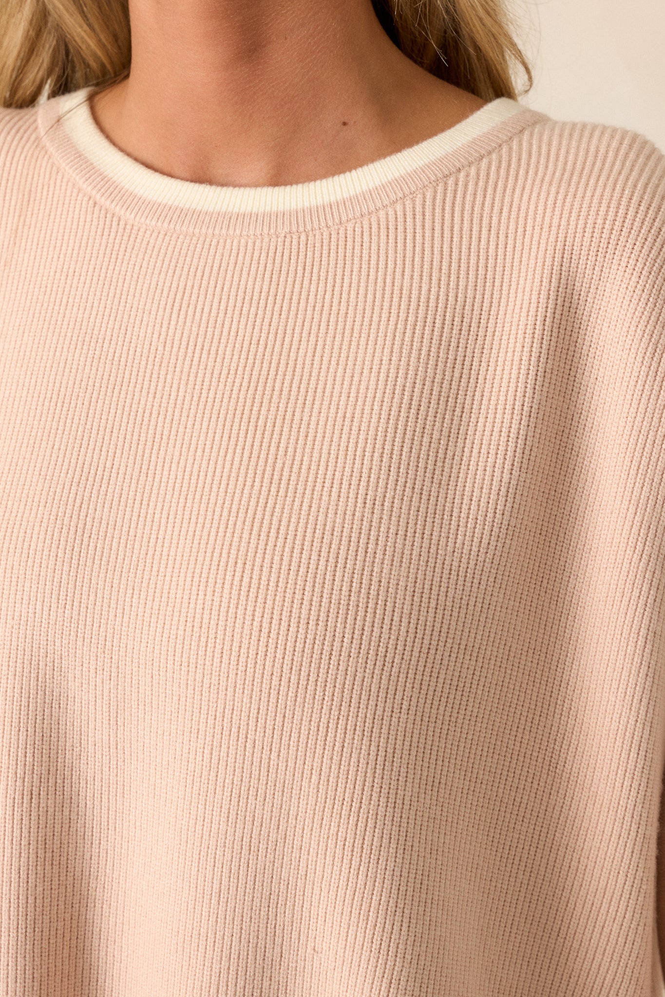 Detailed view of the fabric texture, emphasizing the oatmeal color and the quality of the knit, with a focus on the ribbed knit cuffs.