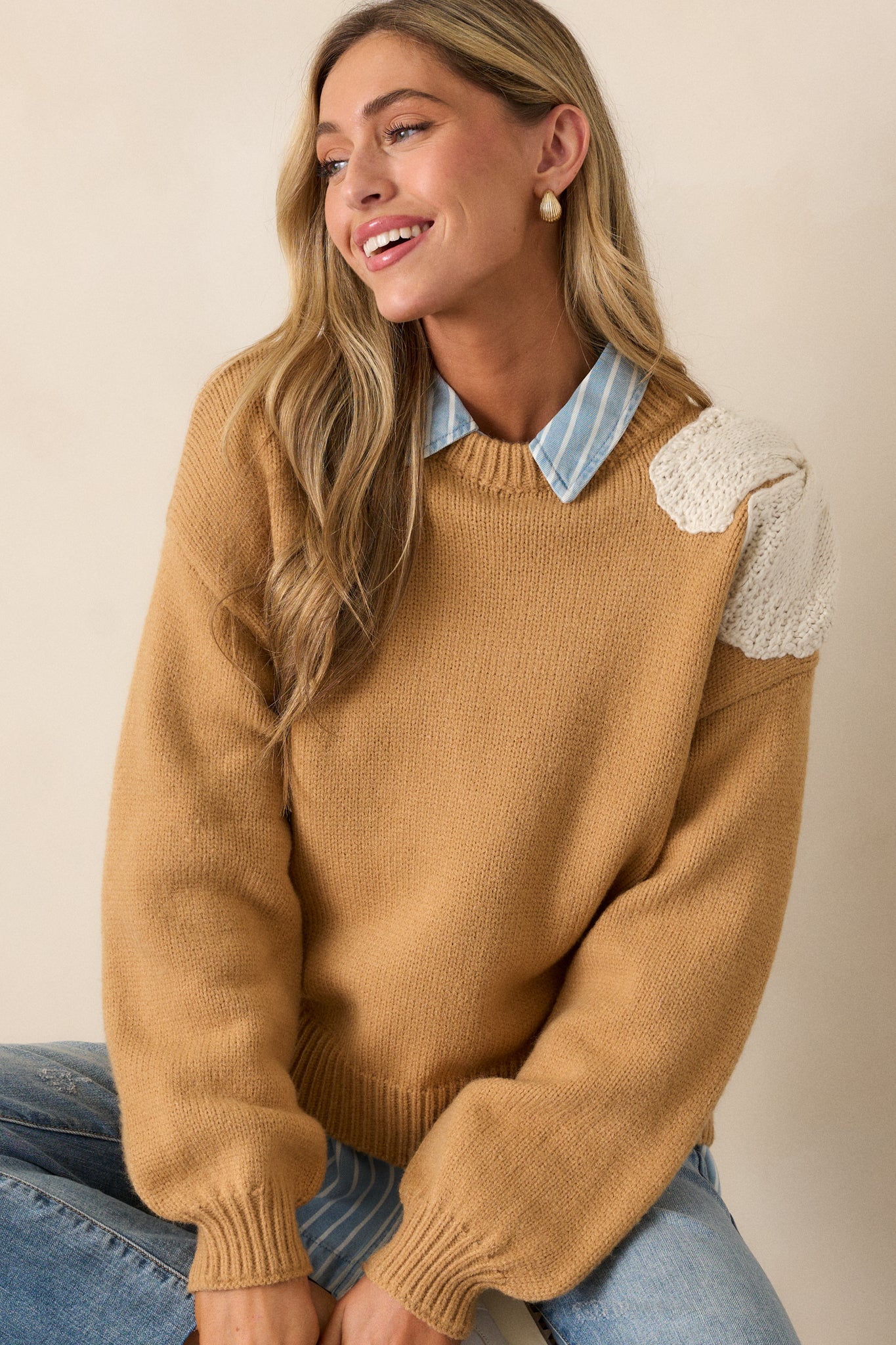 Close-up of the neckline and shoulder, focusing on the ribbed texture around the collar and the delicate crocheted ivory bow.