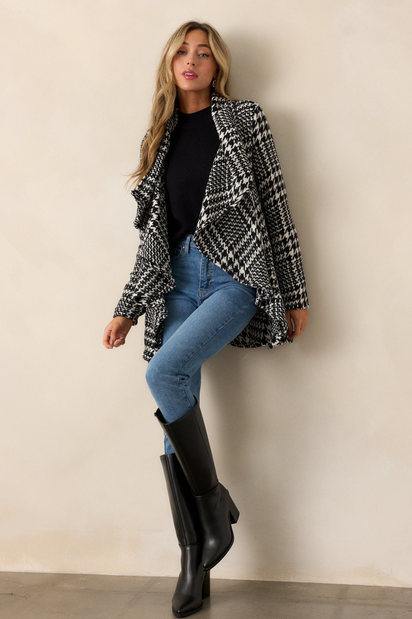 Full body view of the jacket displaying the full houndstooth design and the soft material draping elegantly.