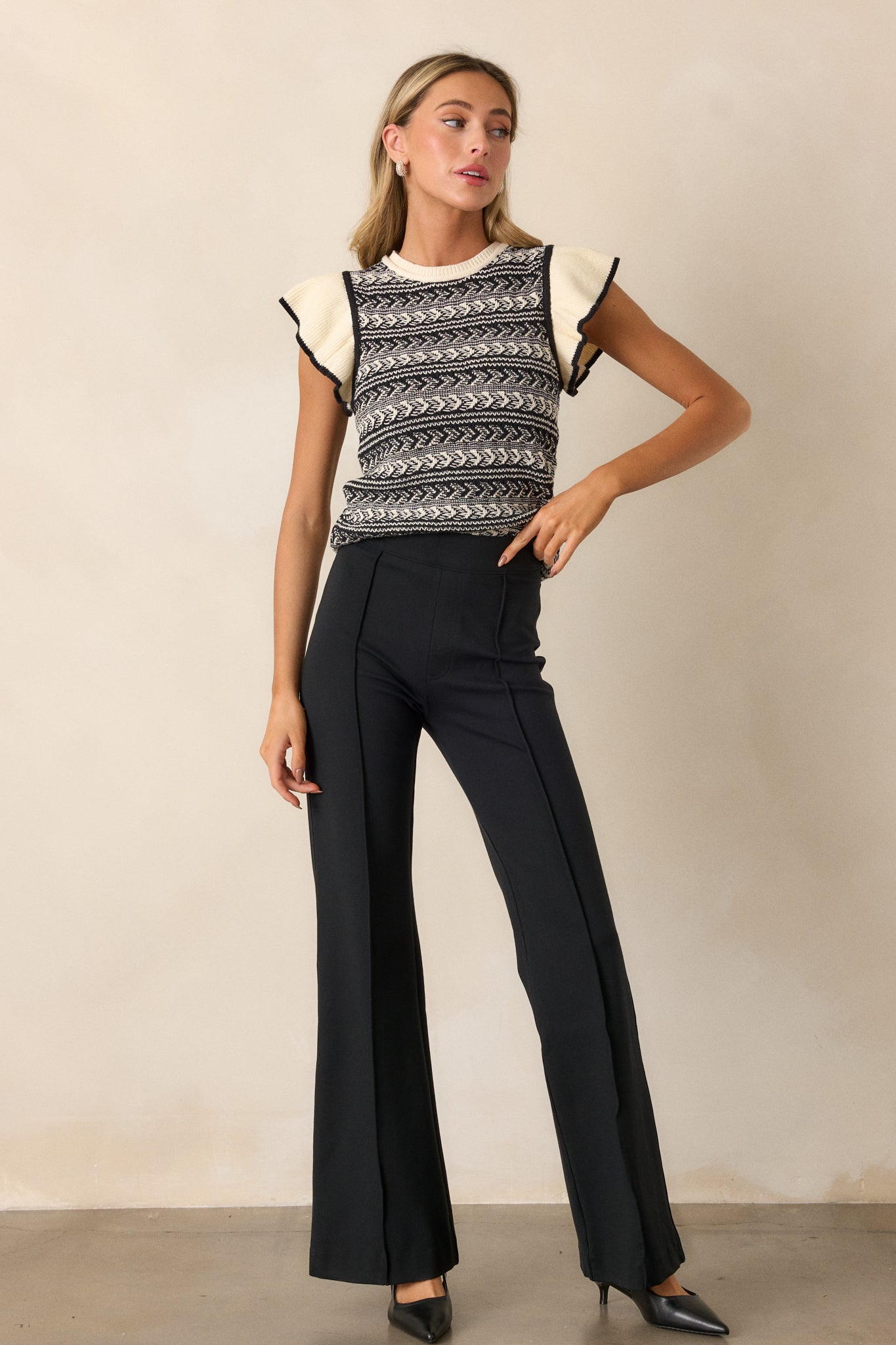 Full length view of the pants emphasizing the flattering fit and sleek silhouette created by the hidden shaping feature, with the model’s posture highlighting the design.