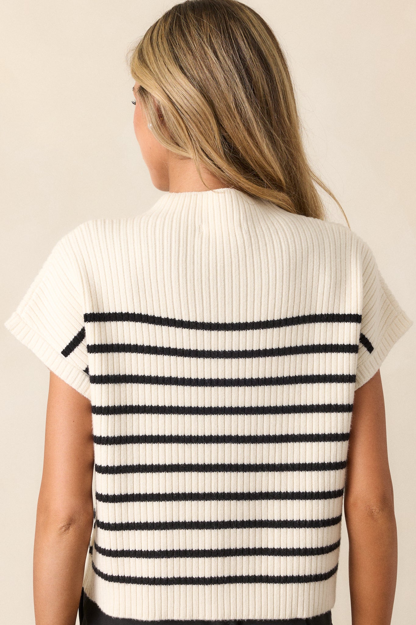 Back view of the ivory stripe top highlighting the black horizontal stripe pattern and the soft thick knit material.