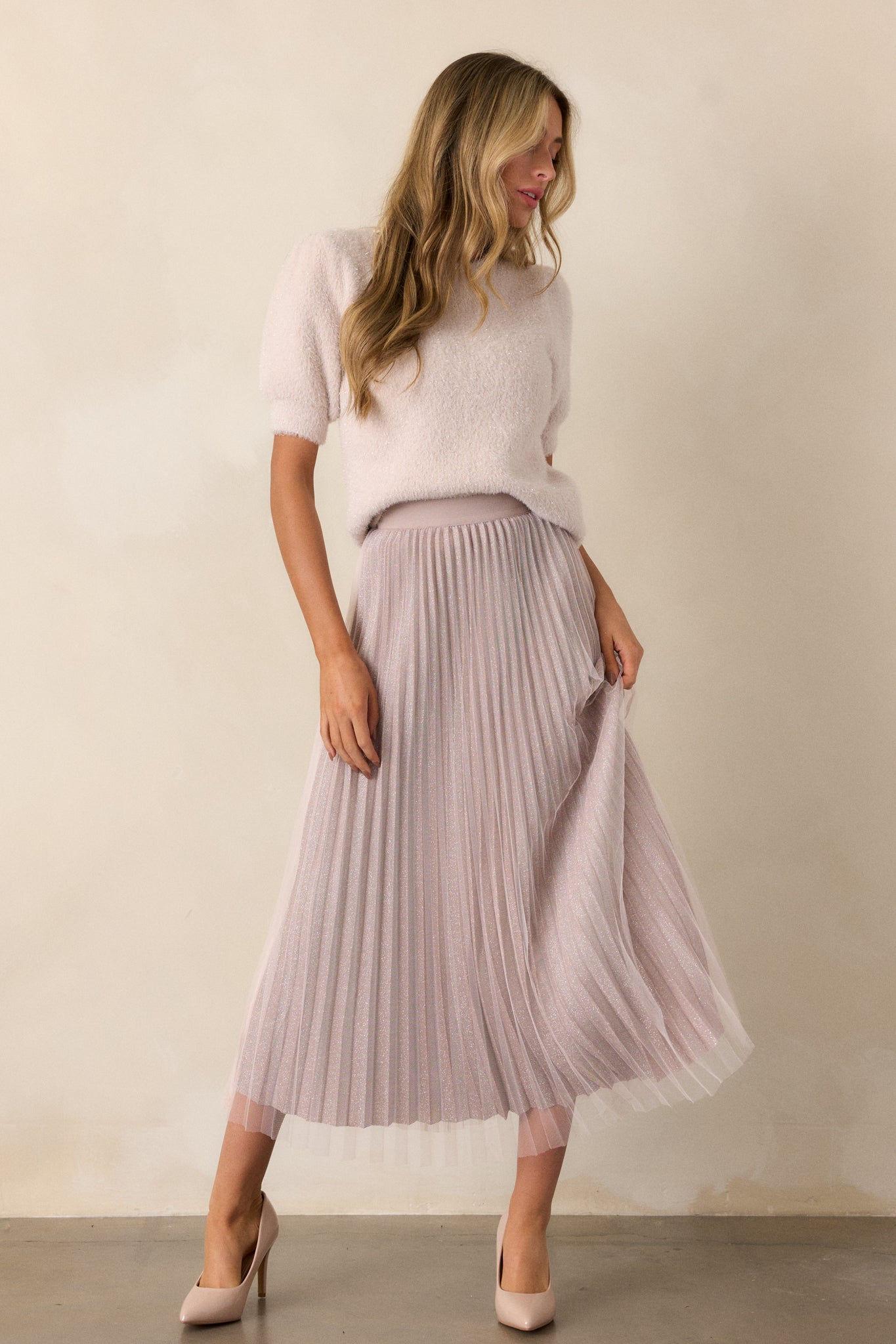 The skirt displayed with its flowing pleated design, emphasizing the contrast between the shimmer underlay and the tulle overlay.