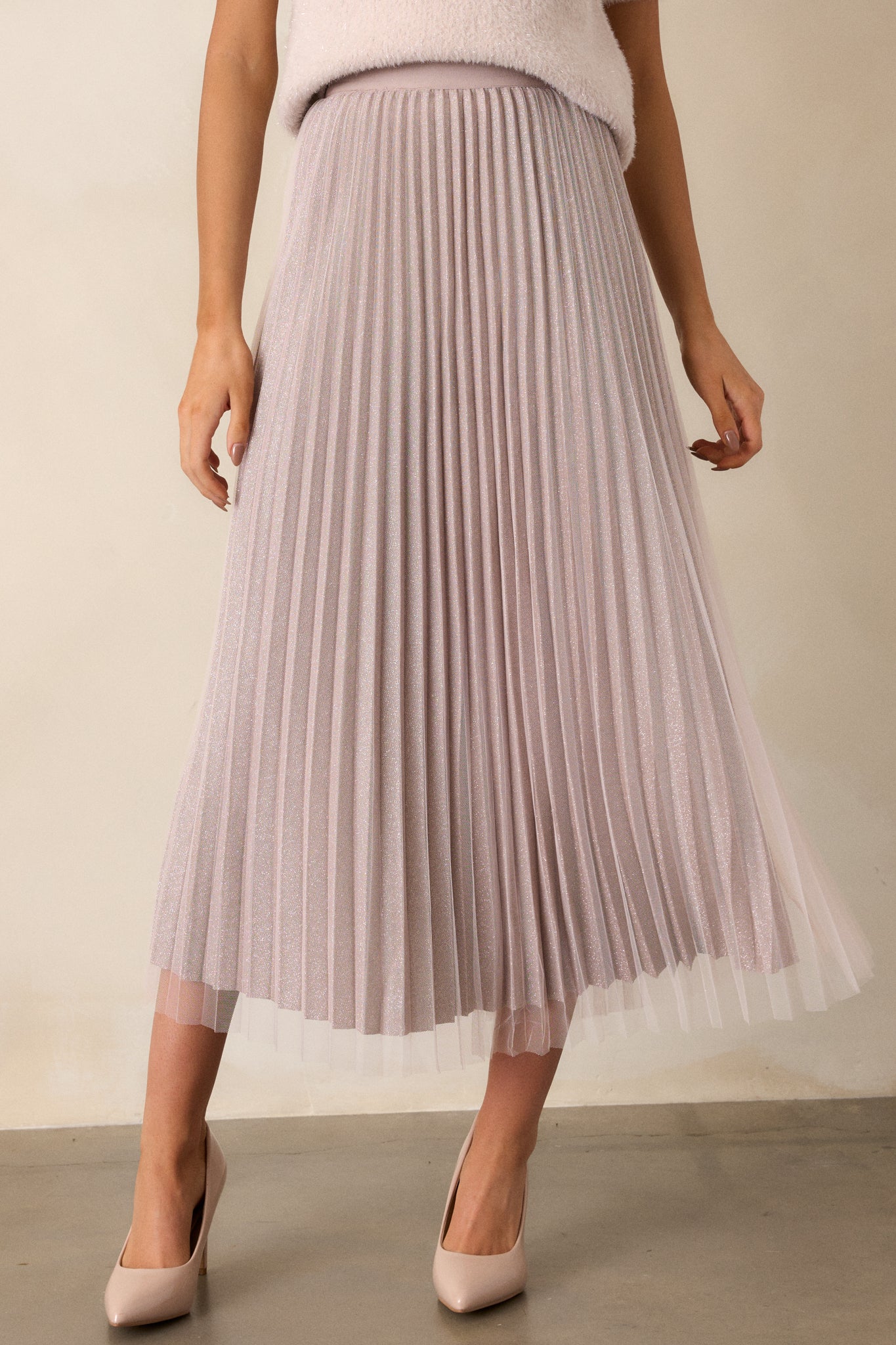 A zoomed-in shot of the pleated shimmer underlay, emphasizing its subtle shine and intricate pleating beneath the tulle.