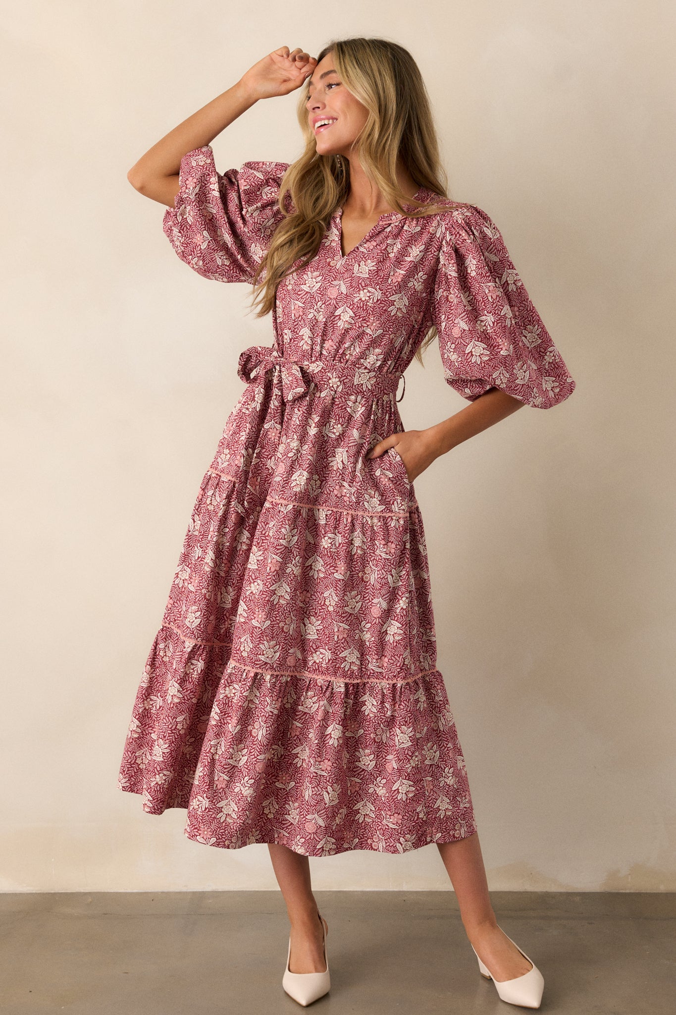 Full body shot that highlights the rich dark sangria color and the contrast of the floral pattern against the tiered skirt's crochet detailing.
