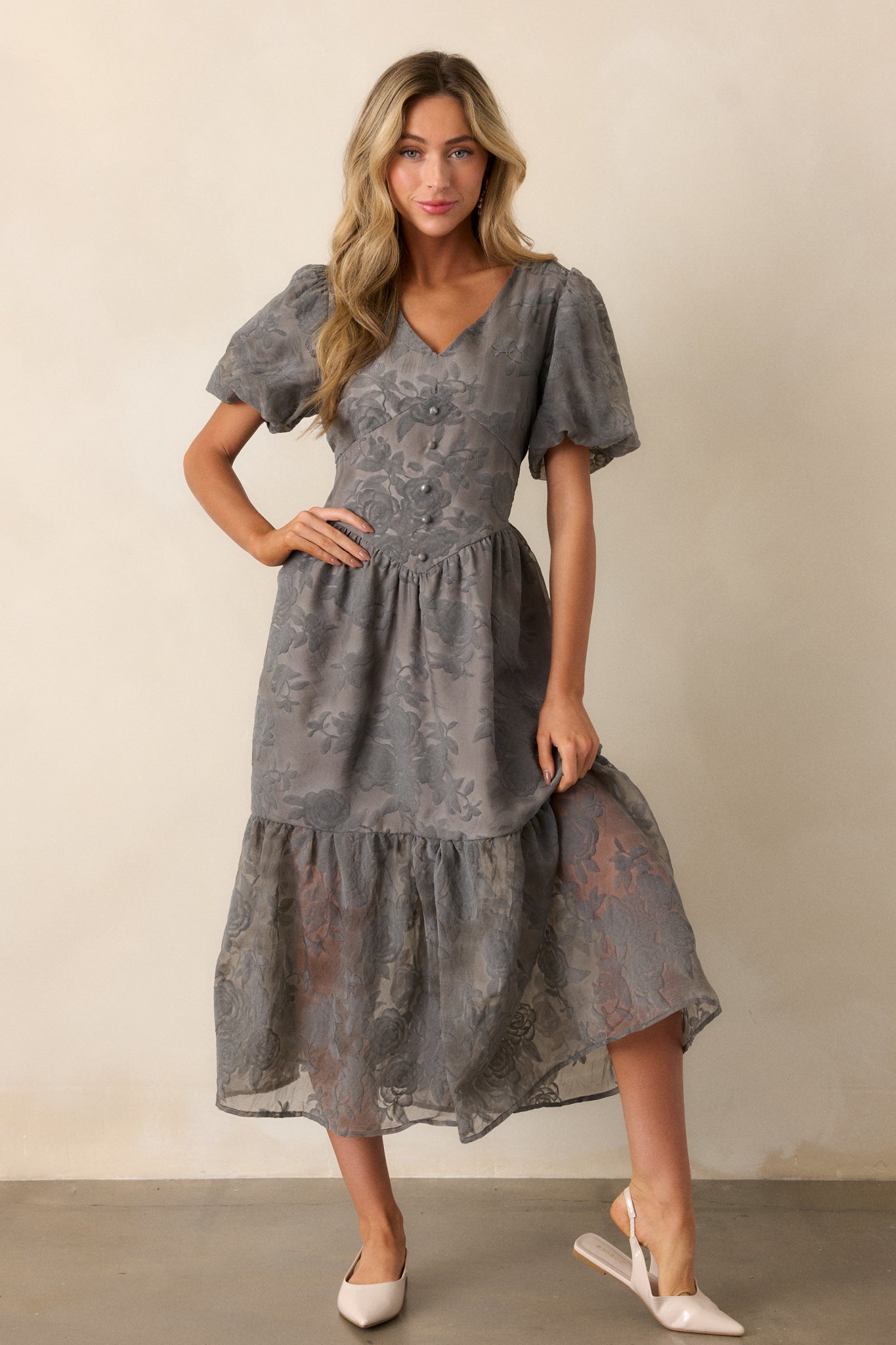 Full length view of the dress, showcasing the short puff sleeves and flowy skirt with a sheer bottom tier.