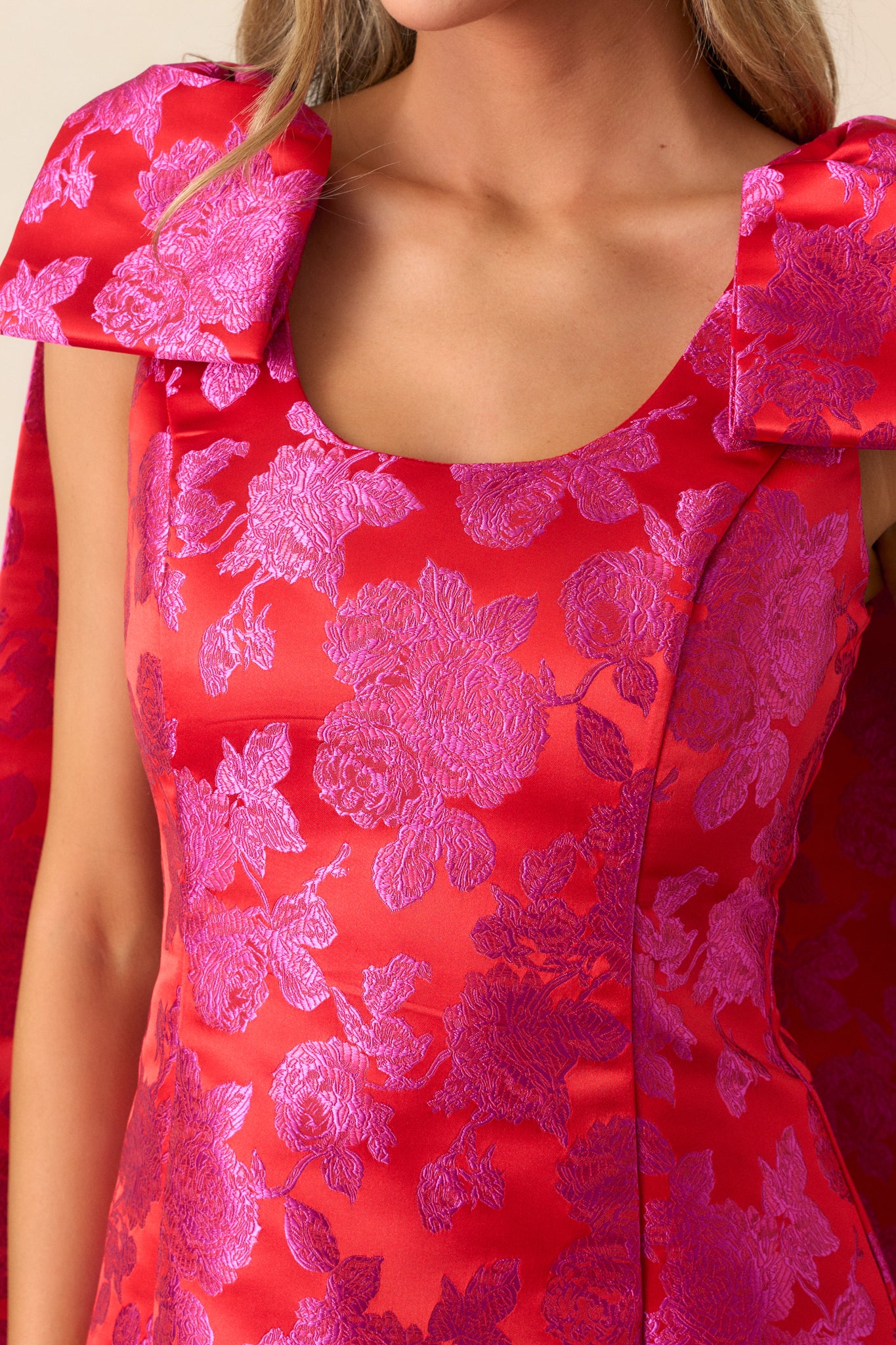 Detailed view of the bow cape-style shoulders, showcasing their structure and placement on the dress.