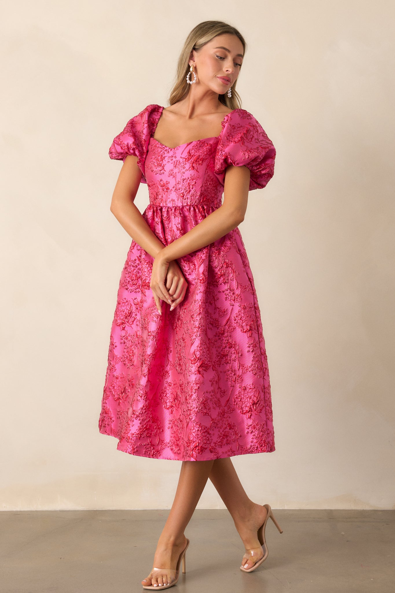 Side view of the pink midi dress highlighting the detailed bodice and puff sleeves with sparkle detailing.