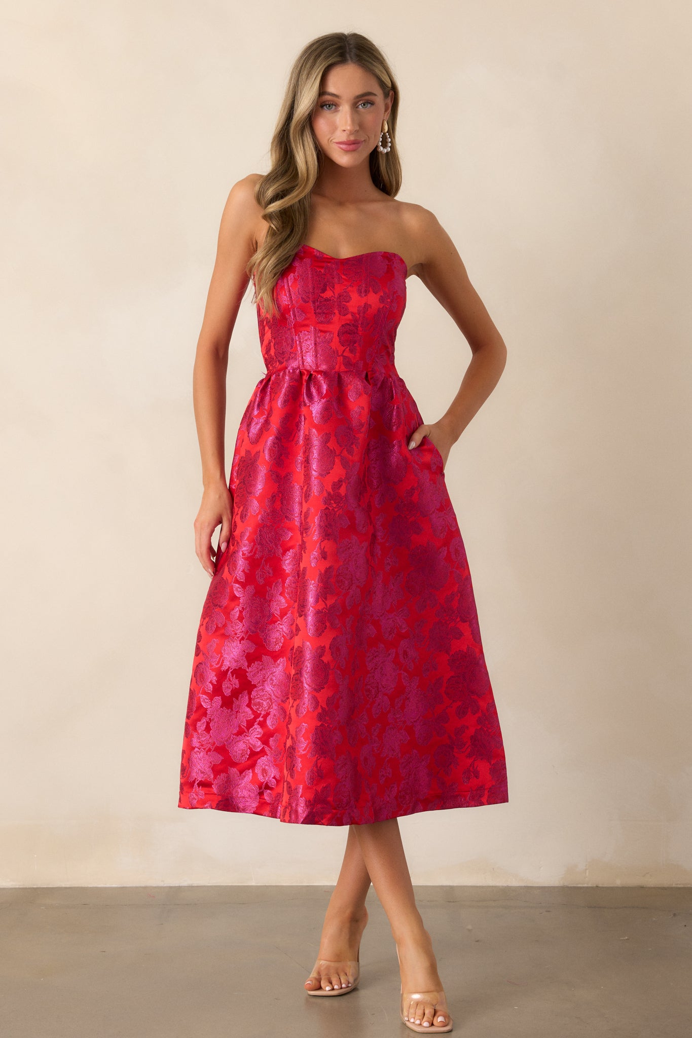 Full-length view of the dress focusing on the strapless neckline, floral jacquard fabric, and how the structured design flatters the silhouette.