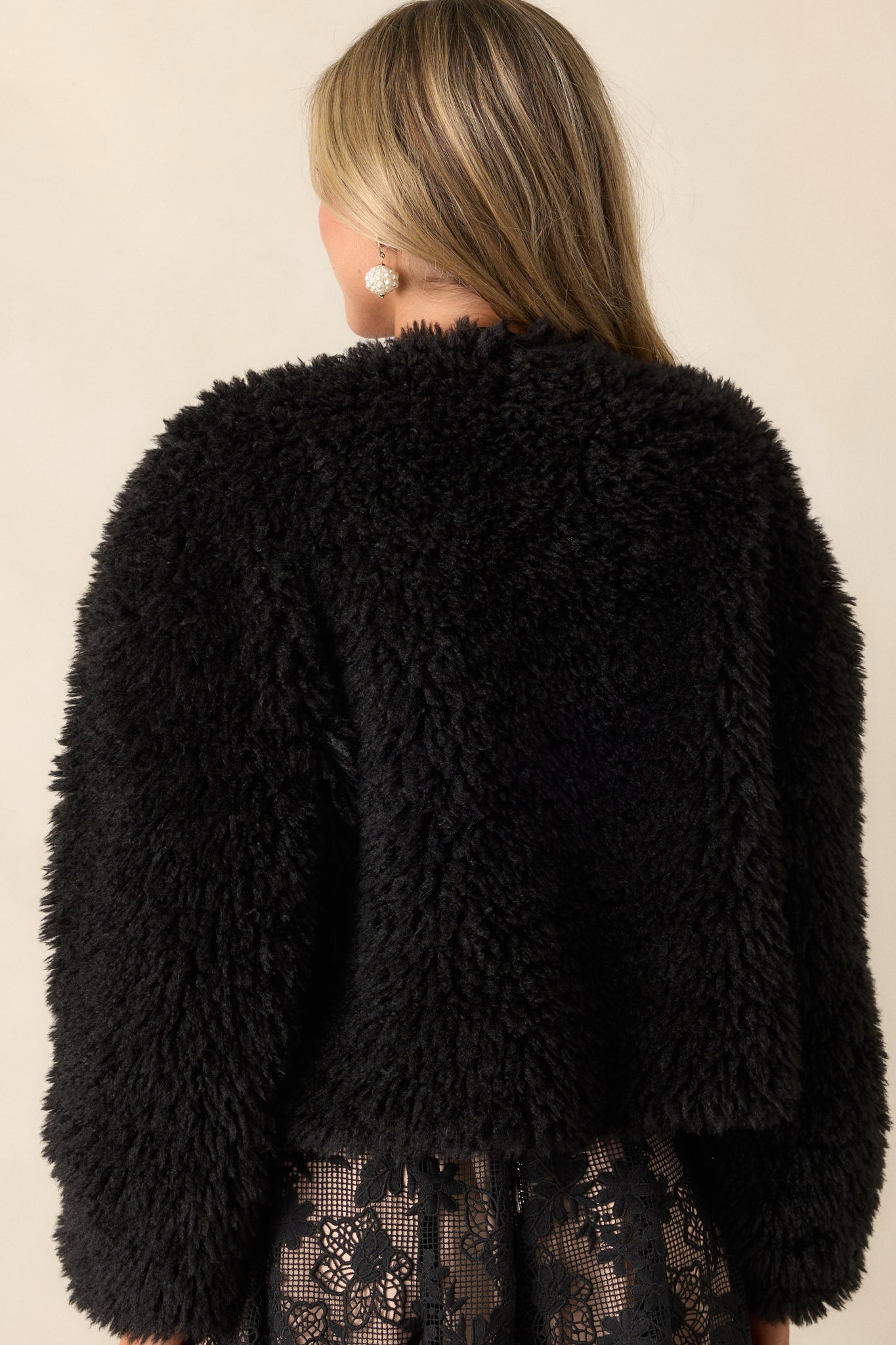 Back view of the faux fur plush jacket, showing the soft texture and smooth finish, with the elastic cuffs at the wrists.