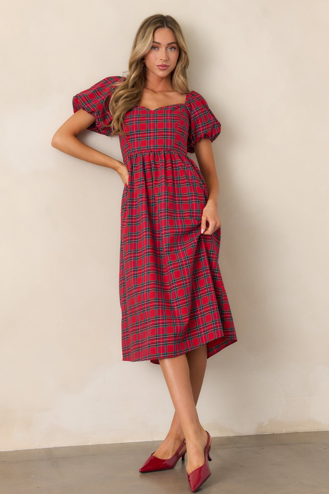 Front view of the red dress showcasing the sweetheart neckline, plaid print, and short puff sleeves.