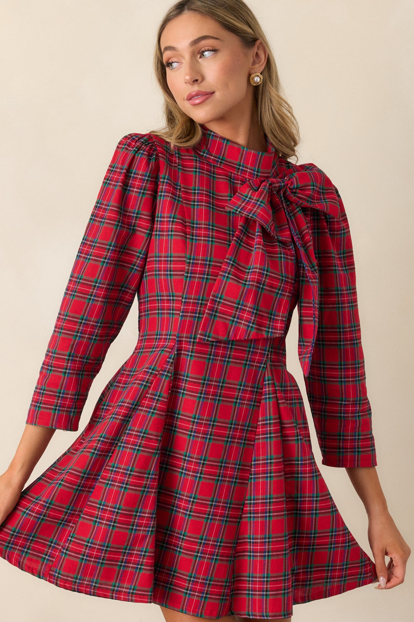 Focused view of the waist and flare of the dress, emphasizing the plaid pattern and structured fit.