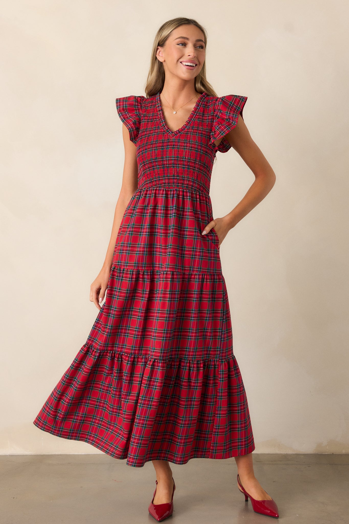 Front view of the red dress emphasizing the plaid pattern and flowy tiered skirt design.