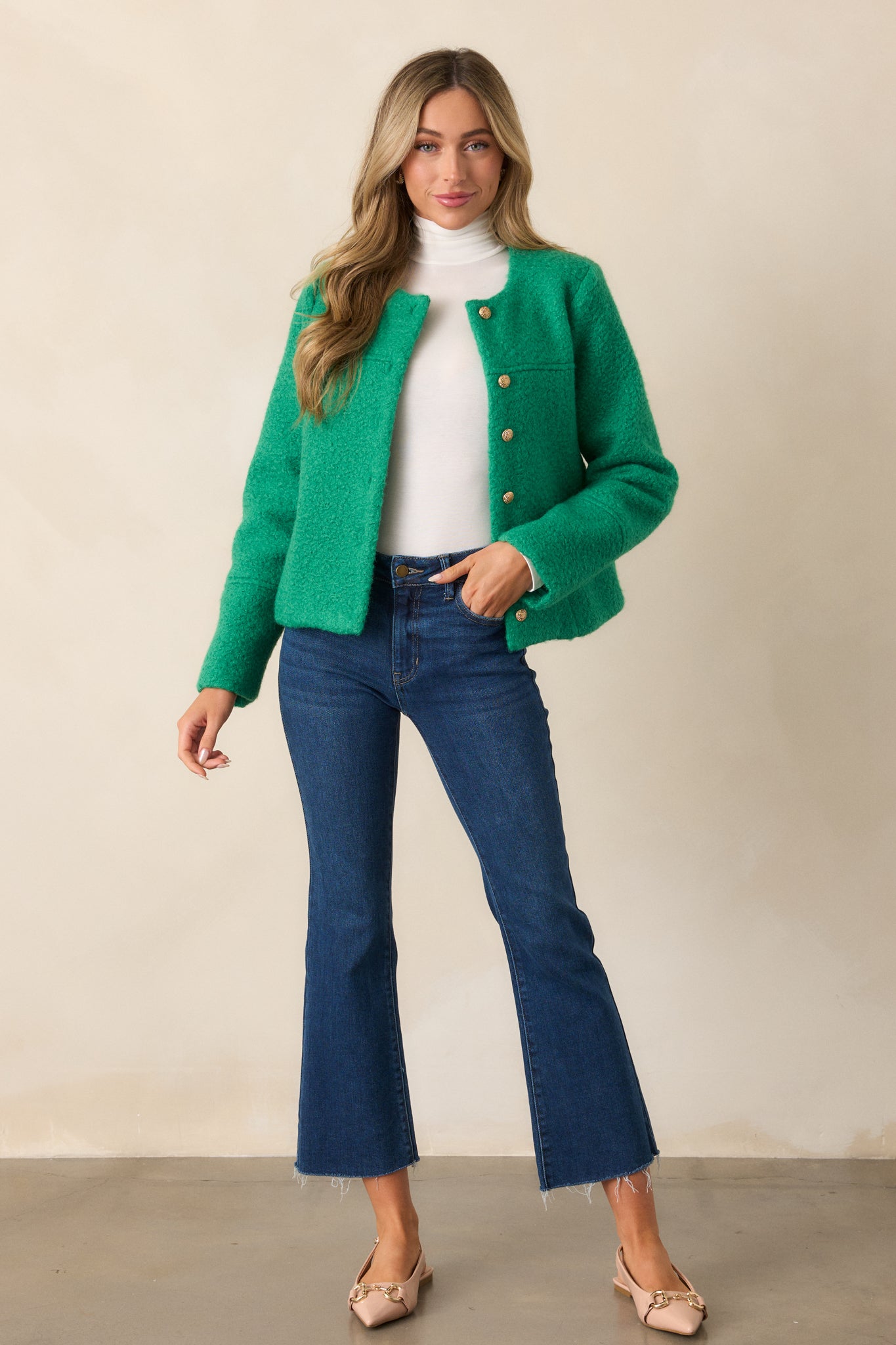 Front view of the kelly green jacket highlighting the high rounded collar, gold-embellished button front, and structured fit.