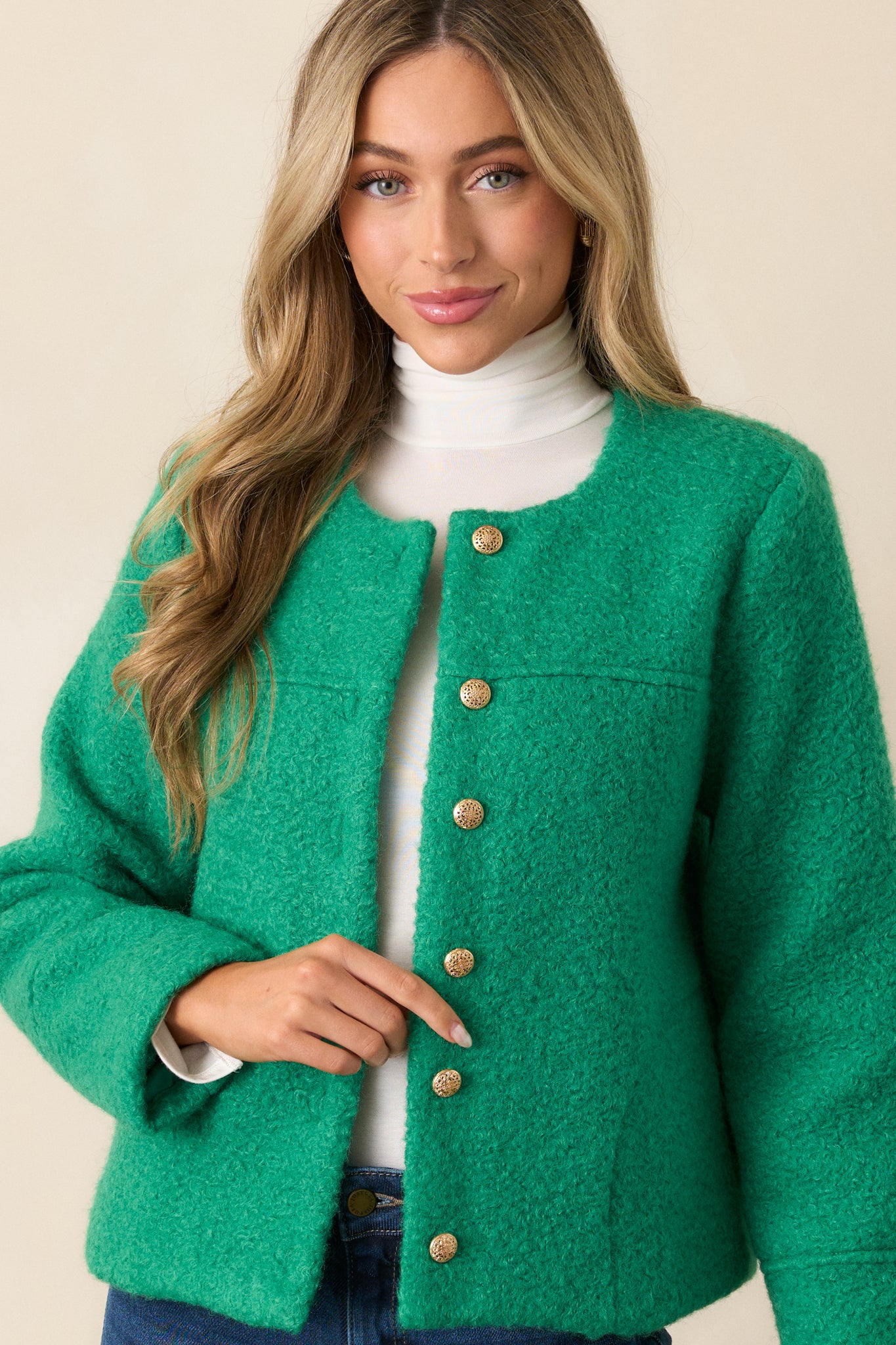 This kelly green jacket features high rounded collar, functional gold embellished button front, structured fit, and long sleeves.