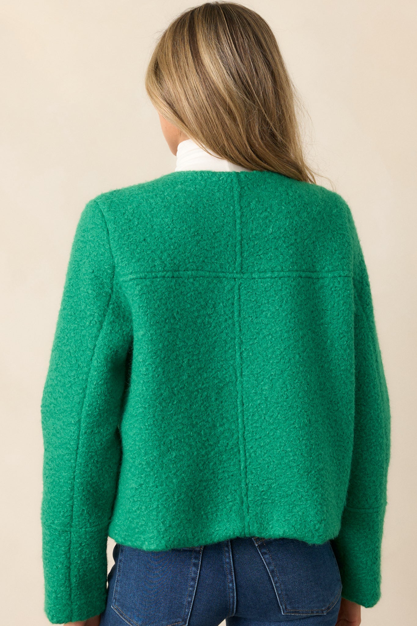 Full back view of the kelly green jacket, highlighting the smooth structured fit and long sleeves.