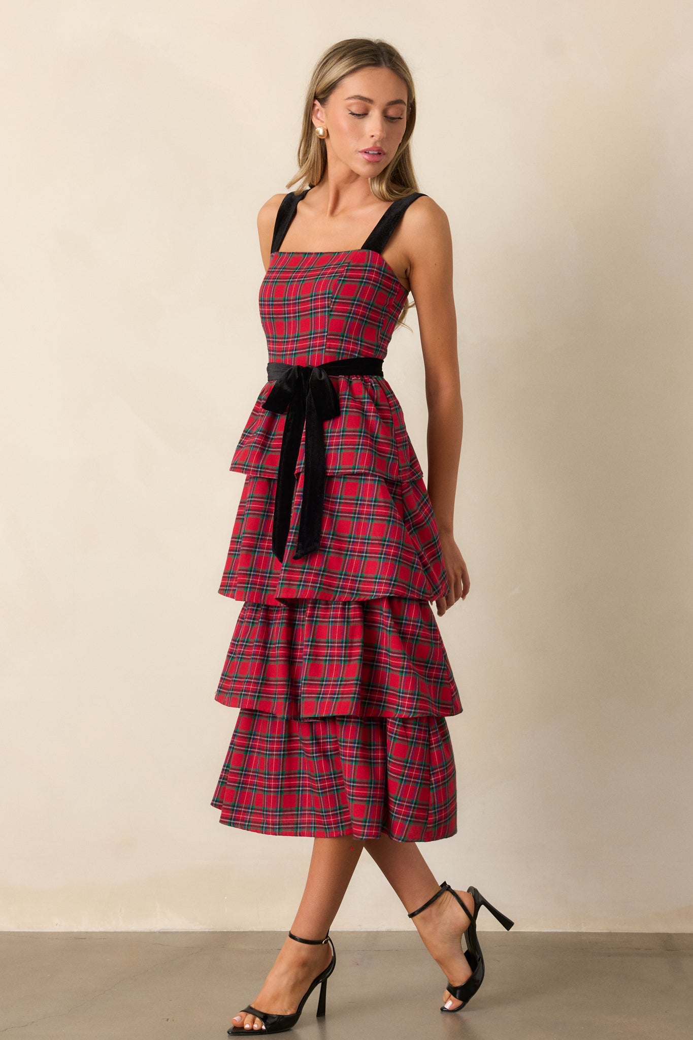 Side view of the red dress, highlighting the tiered skirt, smocked back panel, and optional self-tie belt for an adjustable, flattering fit.