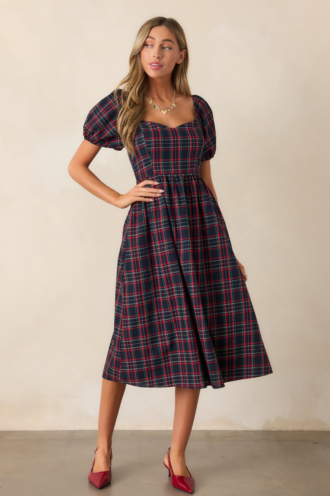 Slightly angled view of the navy dress emphasizing the discrete back zipper and plaid design.