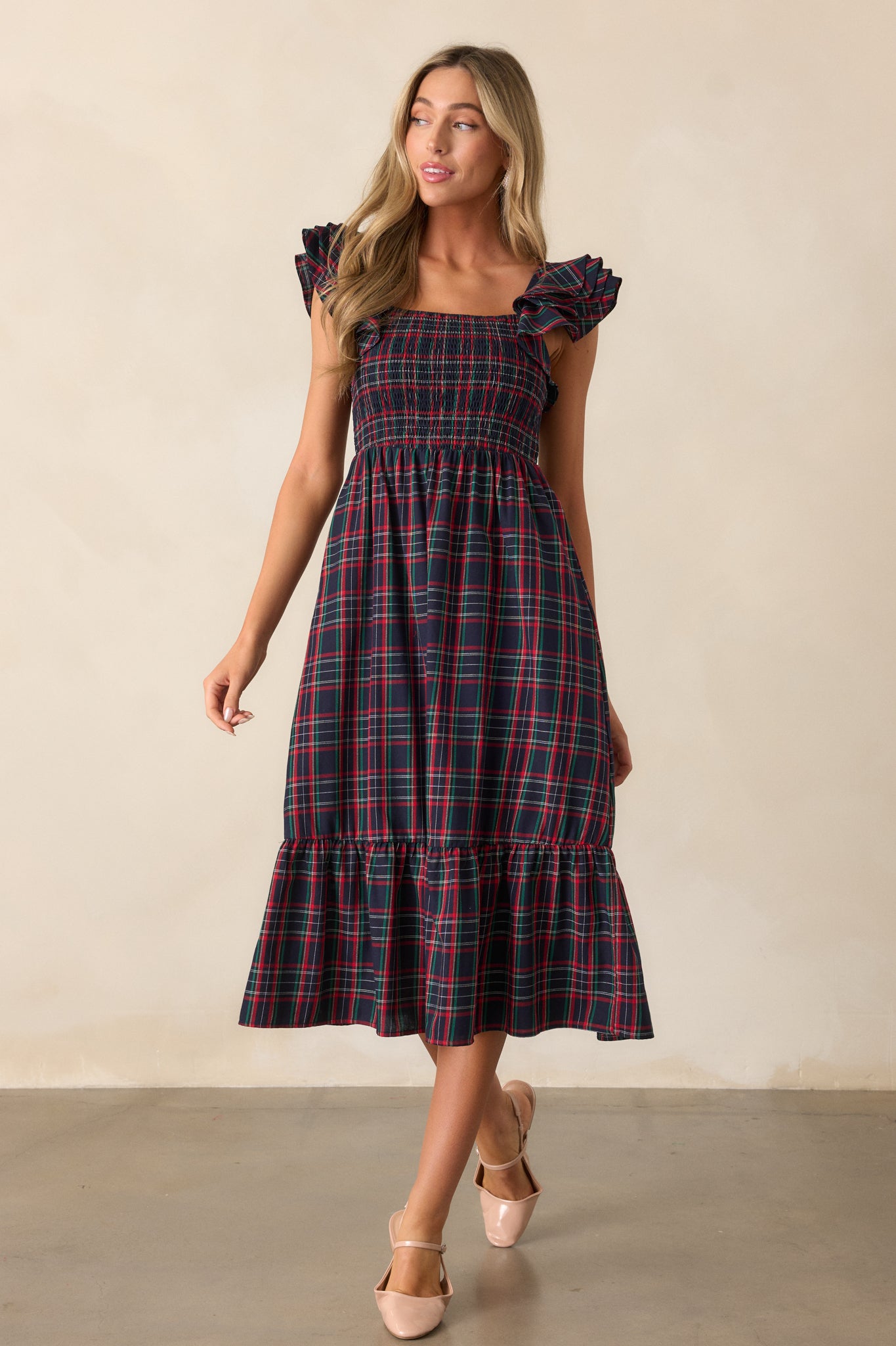 Front view of the navy dress, showcasing the square neckline, plaid print, and relaxed fit of the tiered skirt.