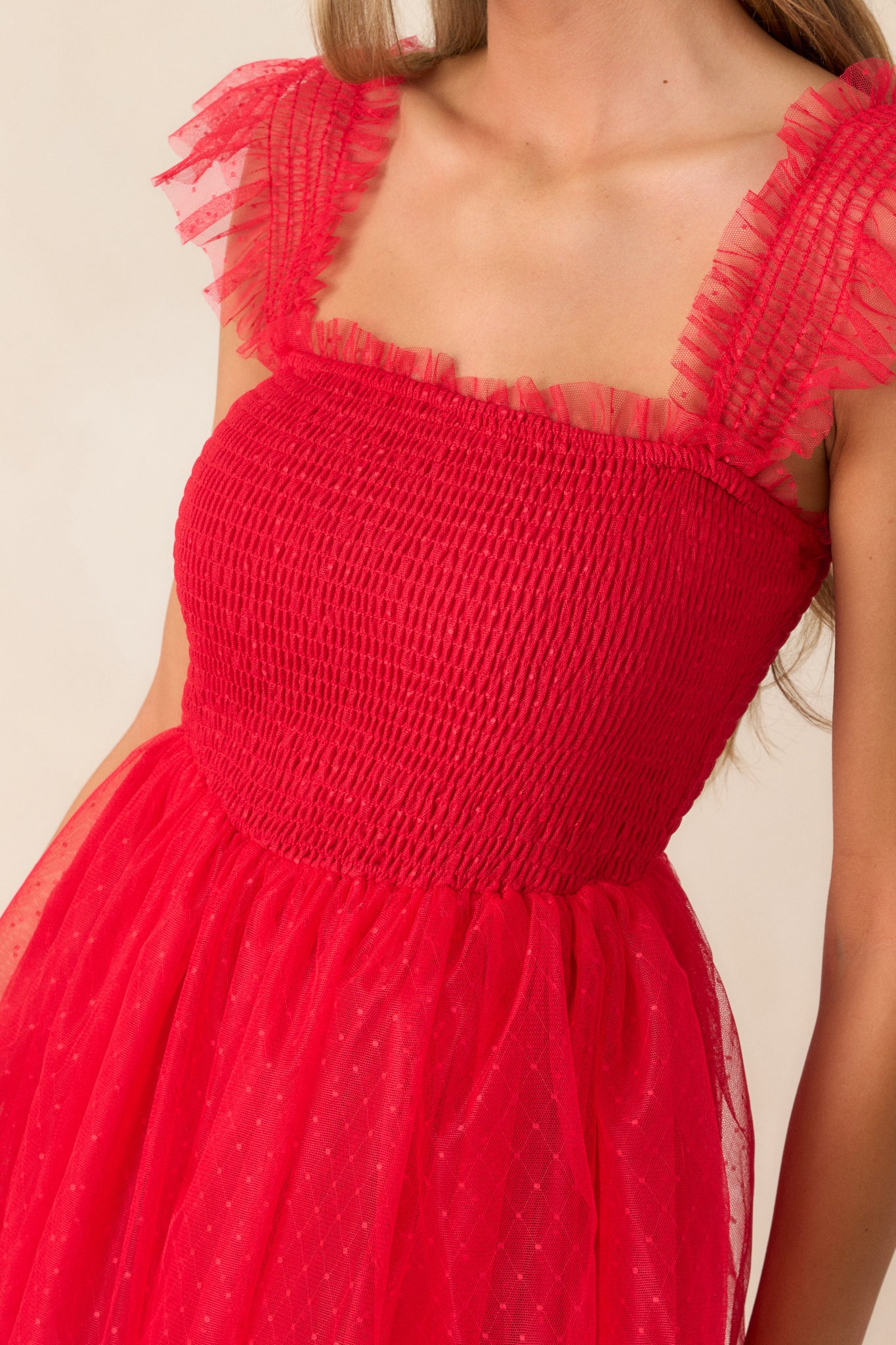 A detailed shot of the smocked bodice, highlighting the intricate texture and polka dot overlay.