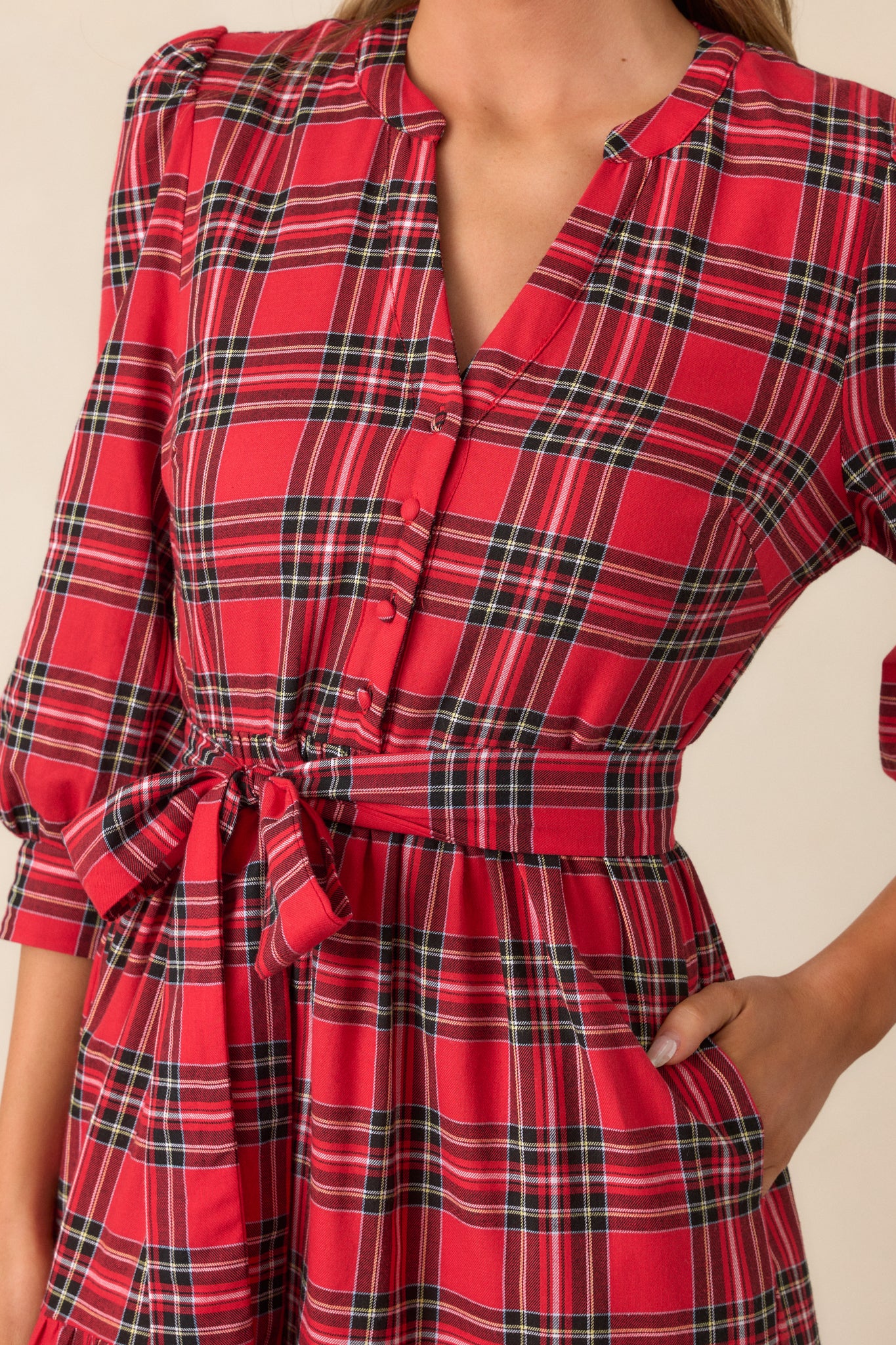 Zoomed-in view of the bodice, highlighting the split v-neckline, functional buttons, and smocked cuffs on the sleeves.