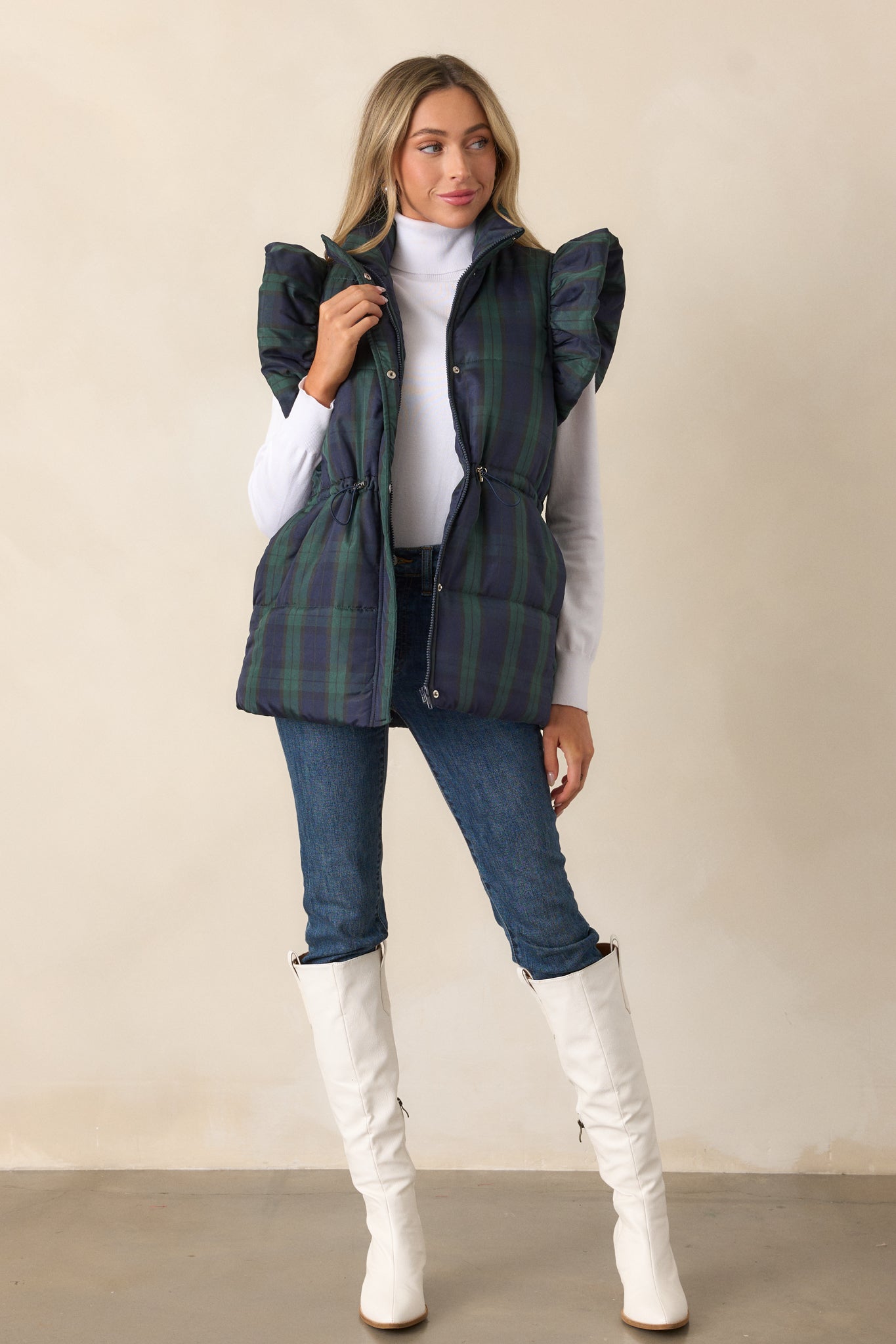 Front view of the navy puffer vest showcasing the collared neckline, plaid pattern, and puffer line detailing.