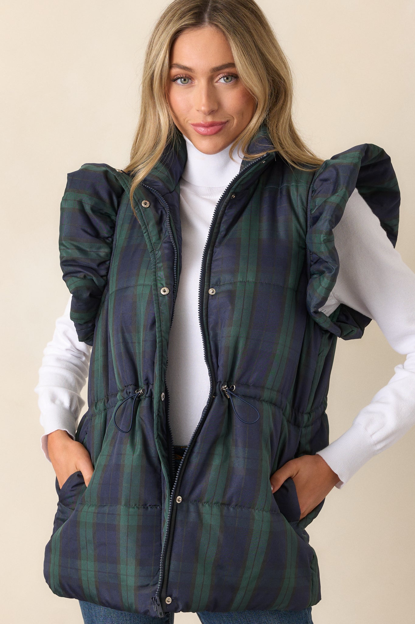 Close-up of the upper bodice showing the collared neckline, plaid fabric, and fluffy flutter sleeves.