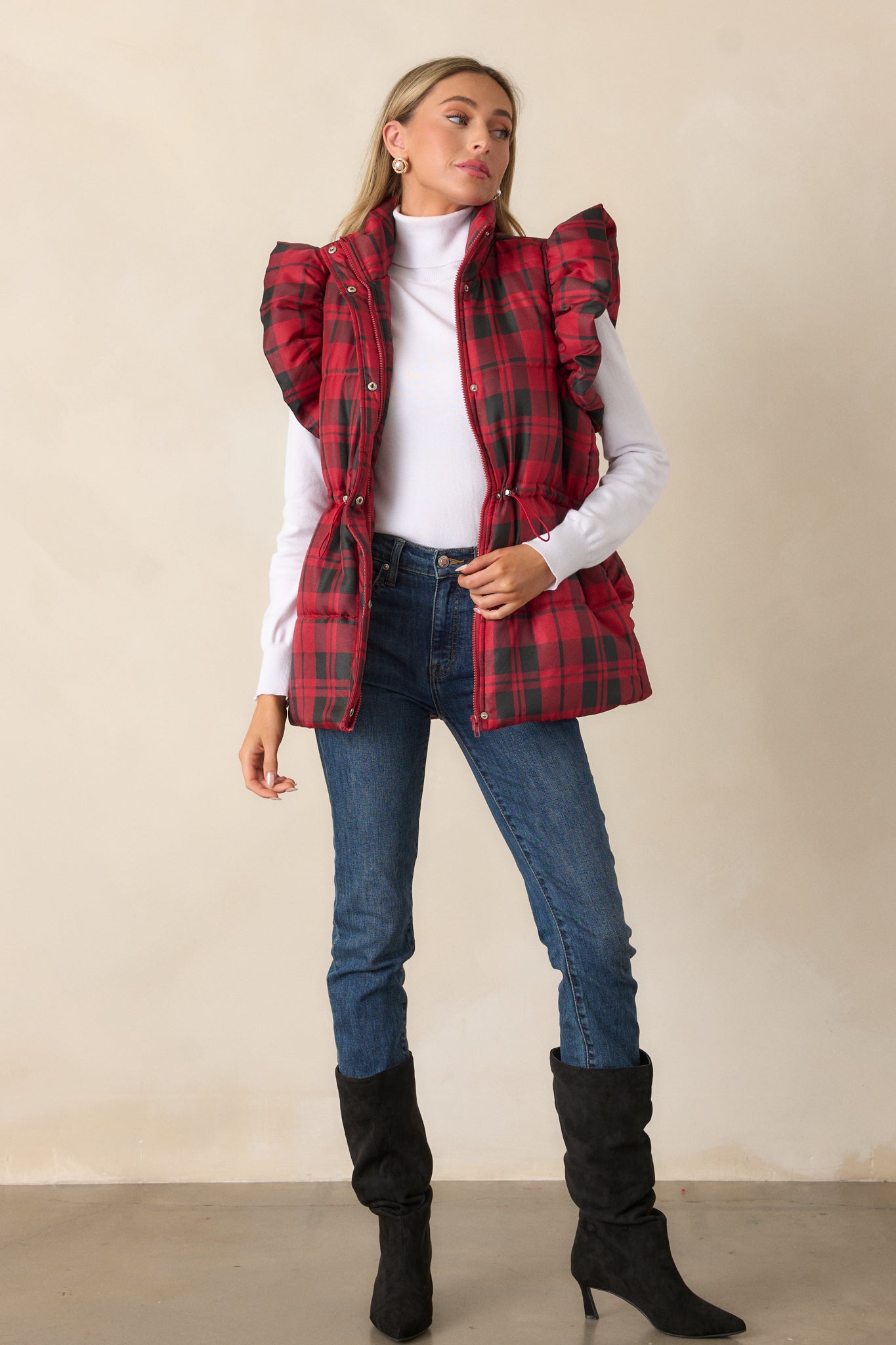 Front view of the red puffer vest showcasing the collared neckline, plaid pattern, and puffer line detailing.