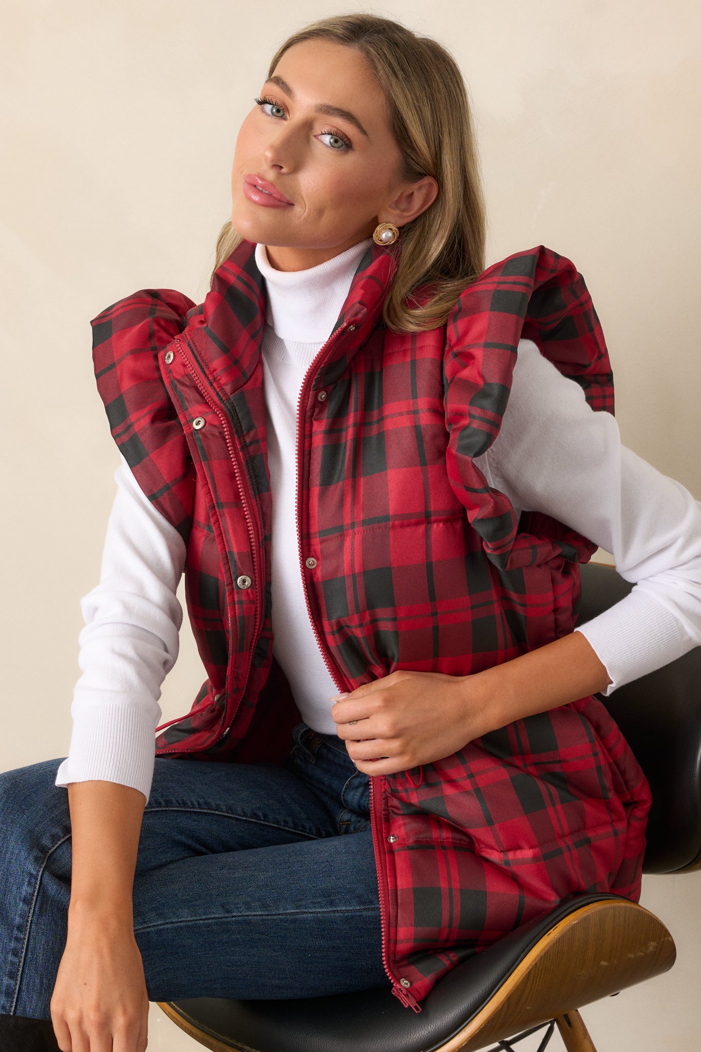 Side view of the red puffer vest highlighting the functional hip pockets and the fluffy flutter sleeve detail.