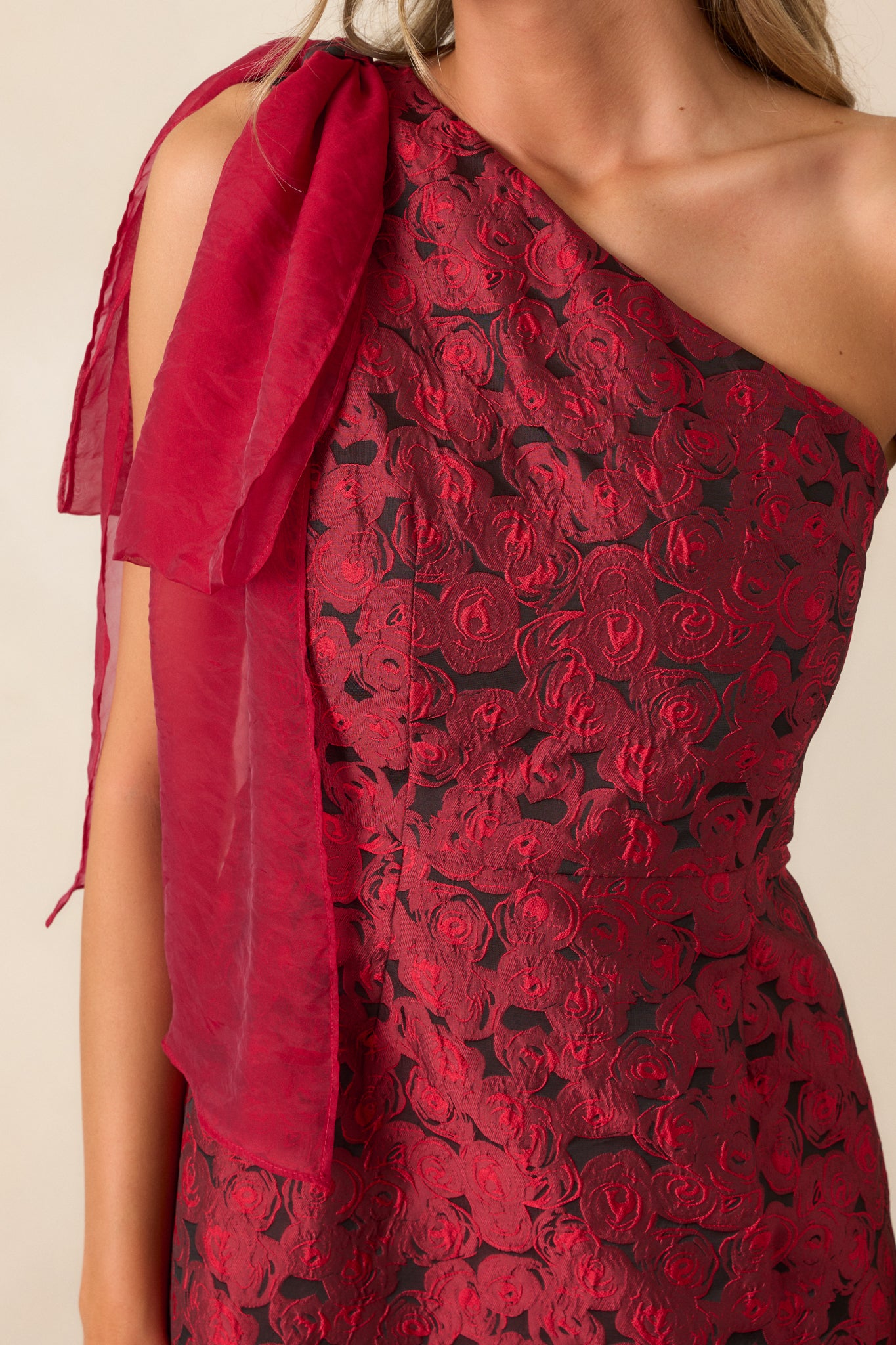 A detailed shot focusing on the bow detail at the neckline and the intricate rose jacquard fabric.