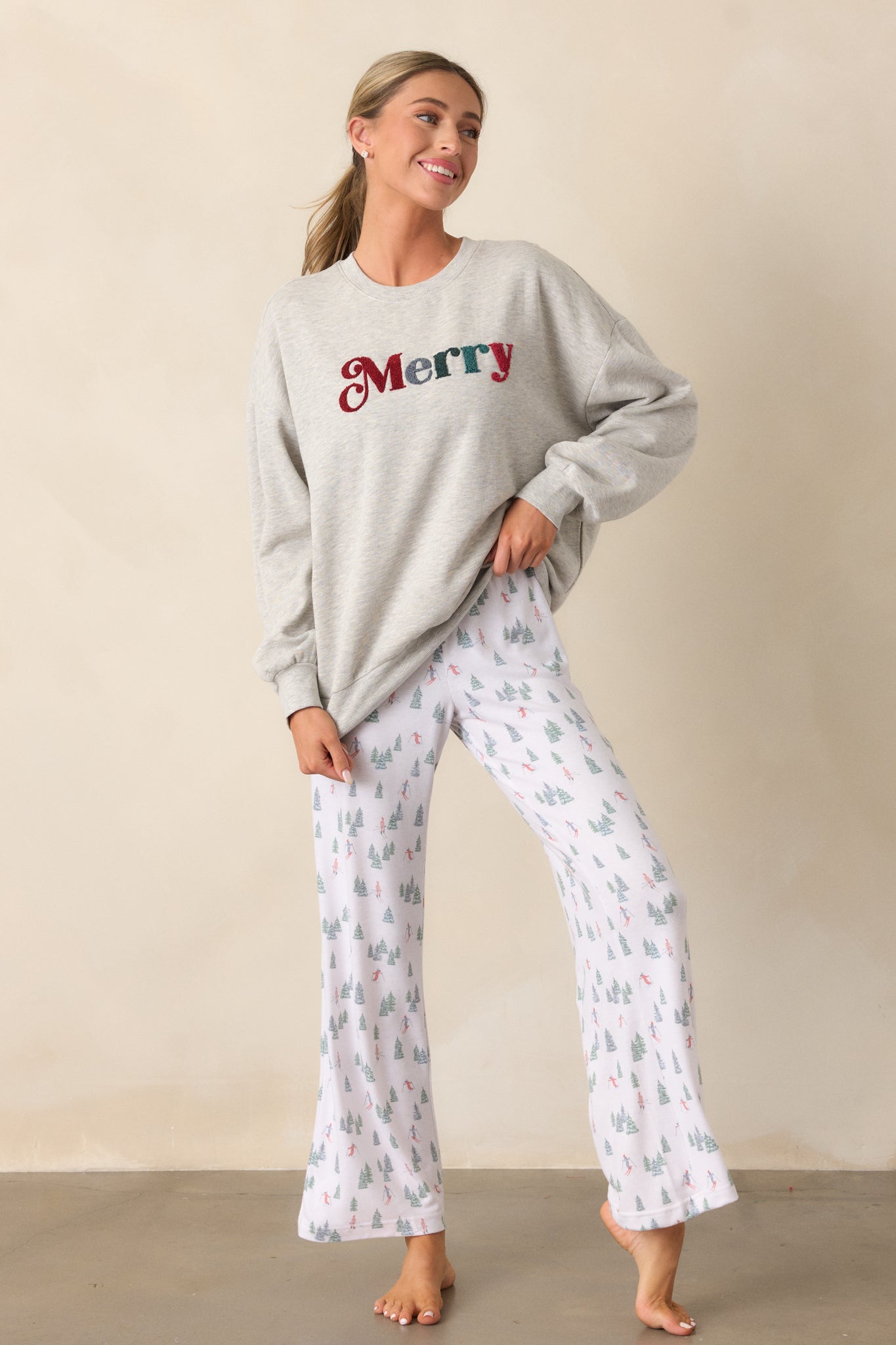 A full-body view of the ivory pants, showcasing the high rise with a smocked waistband, relaxed fit, and beautiful alpine skier pattern in a full-length design.