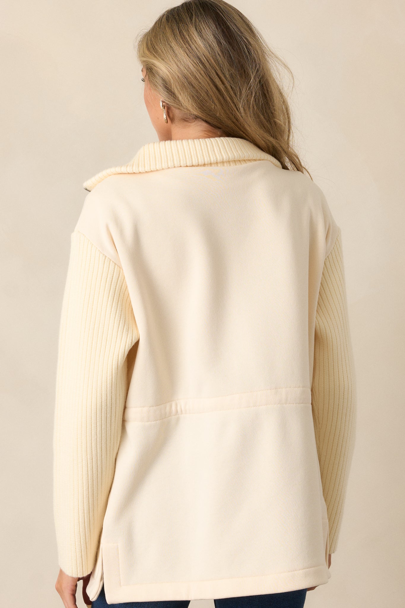 The back view of the ecru jacket, featuring a seamless blend of contrasting fabrics and a clean, tailored silhouette.